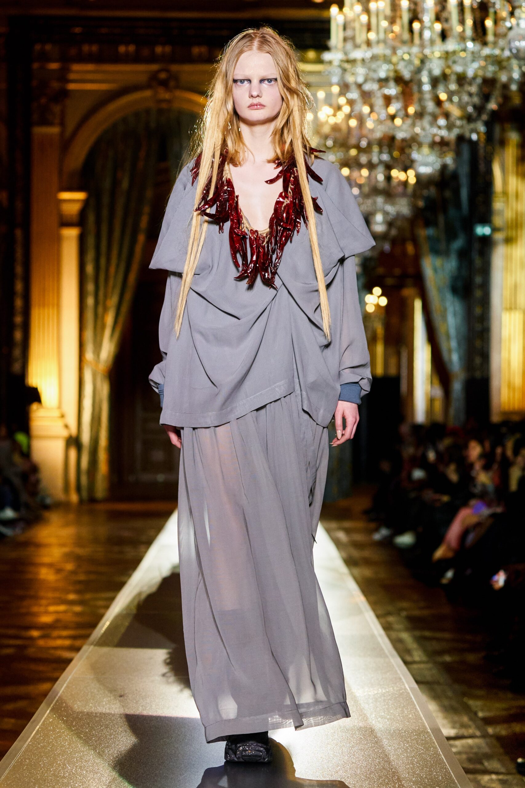 gray flowing maxi dress with beaded necklace