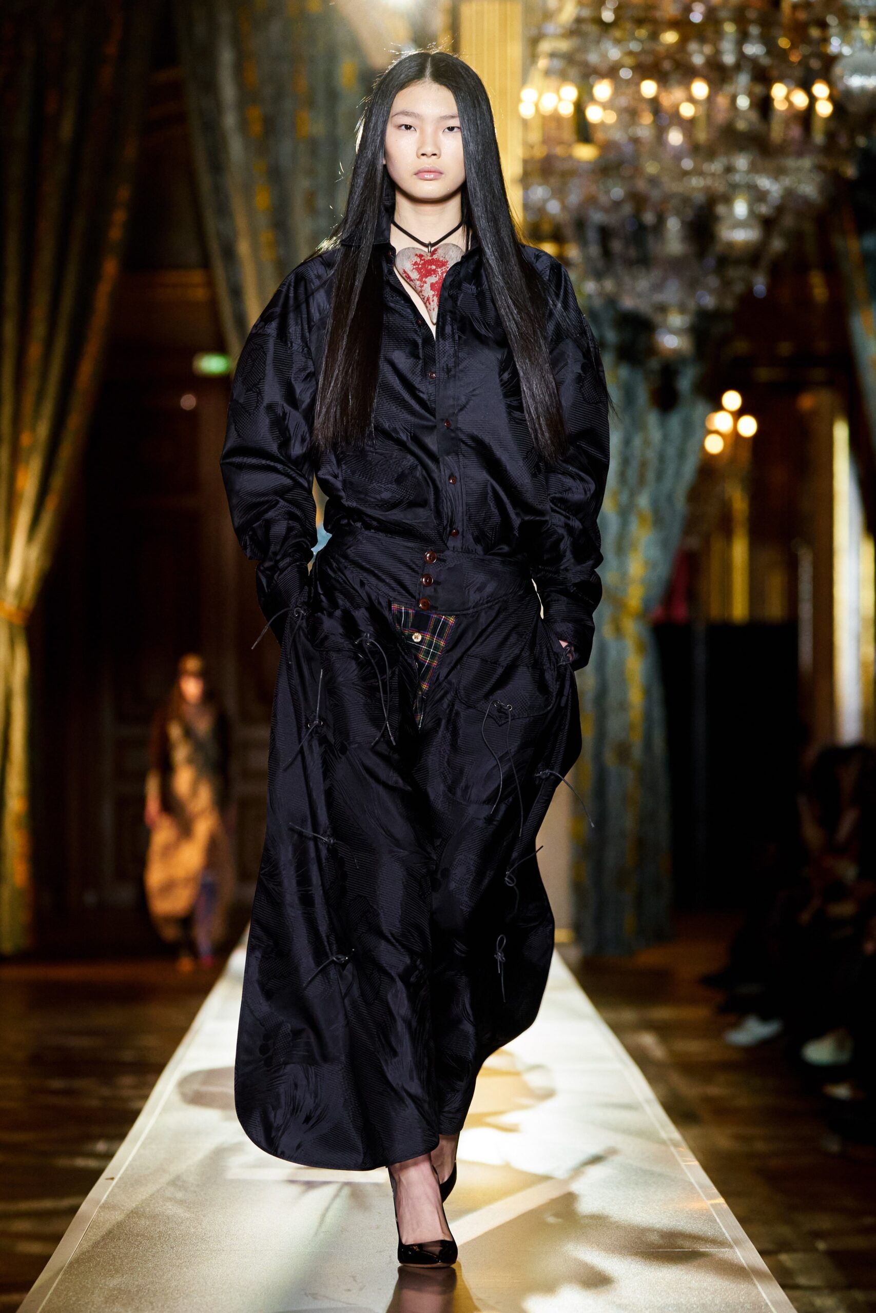 black silk relaxed coat and red silk fitted dress