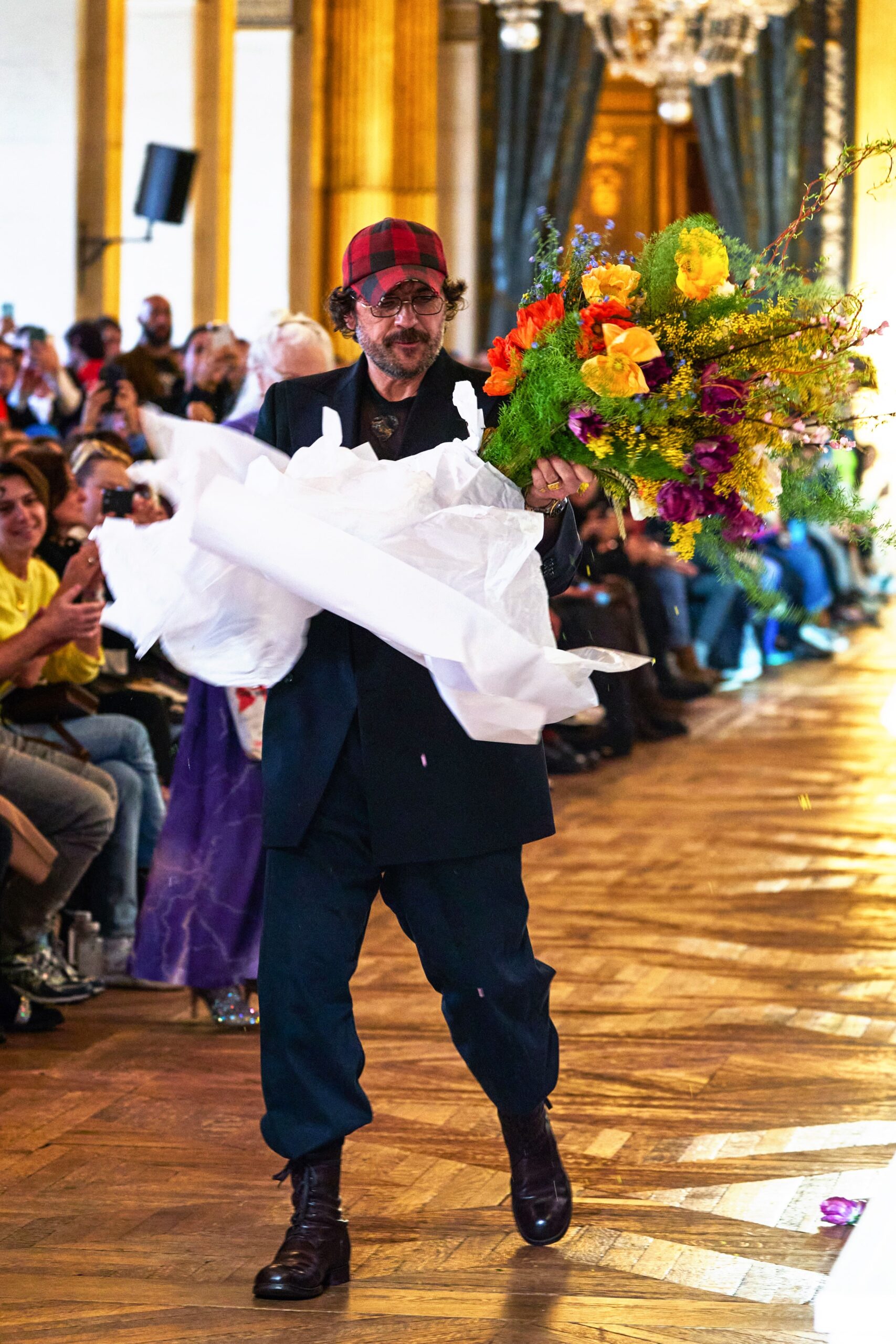 black tailored suit with red hat