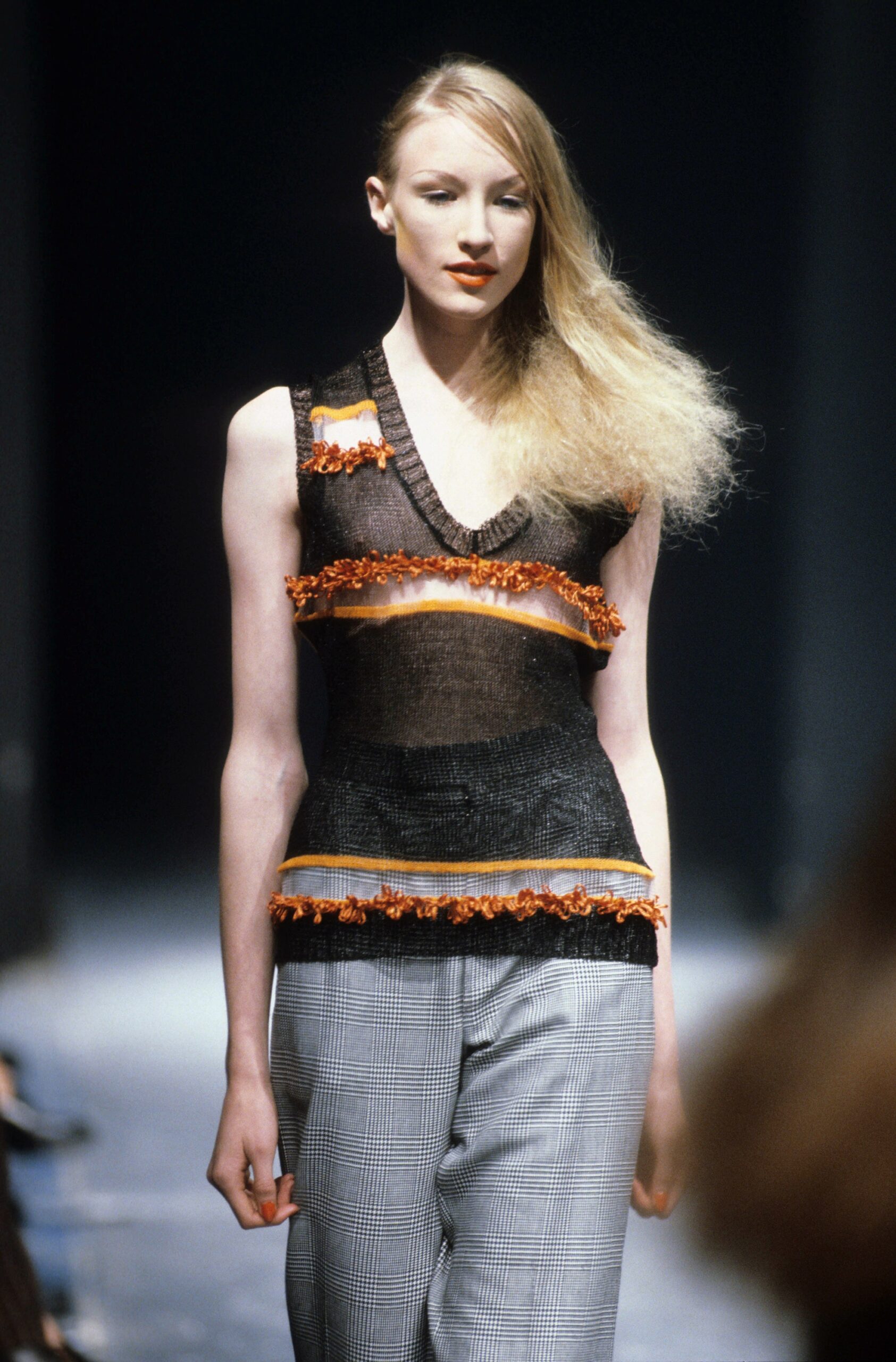 black ruffled top with gray pants