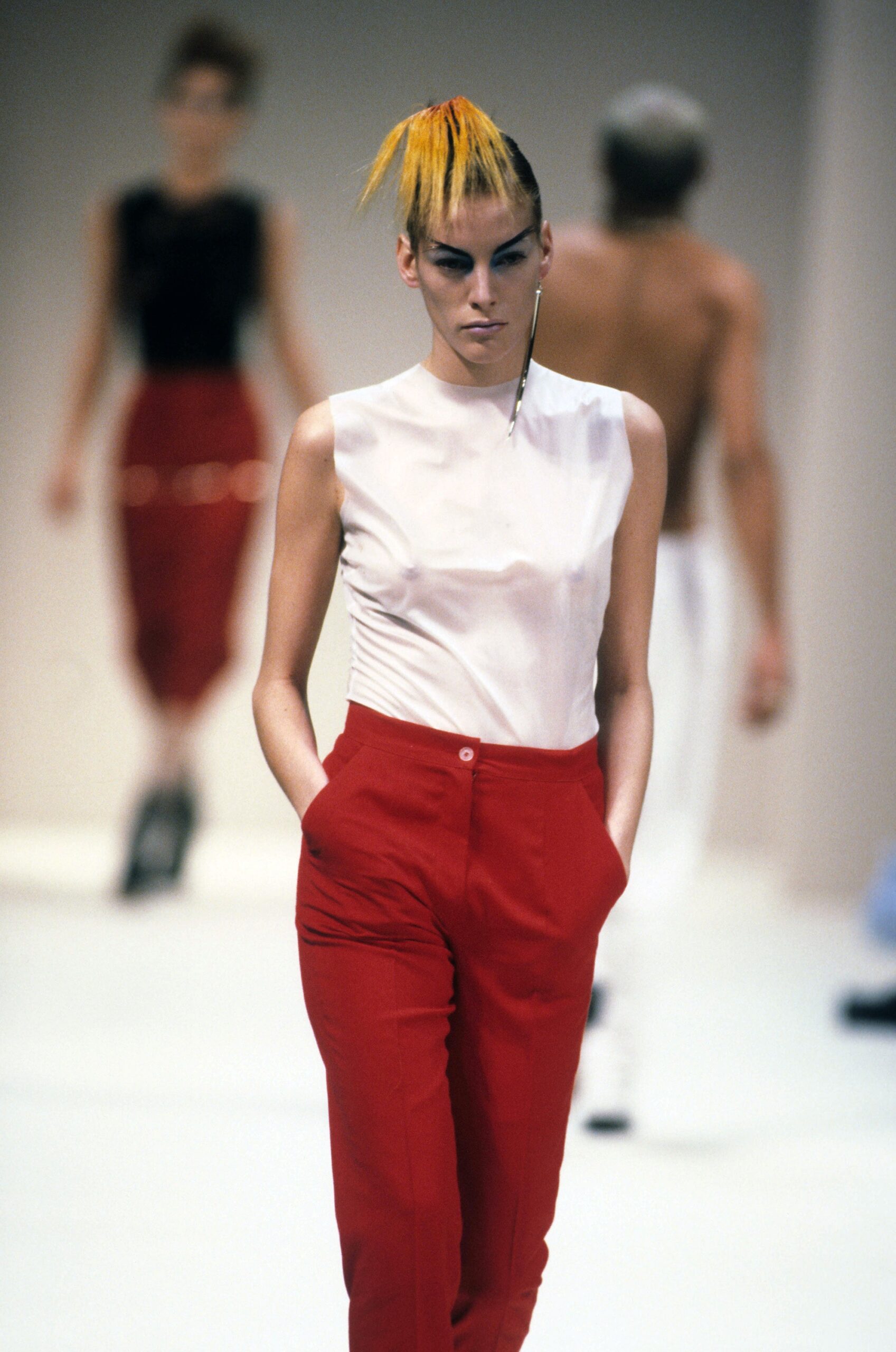 white silk sleeveless top and red tailored pants