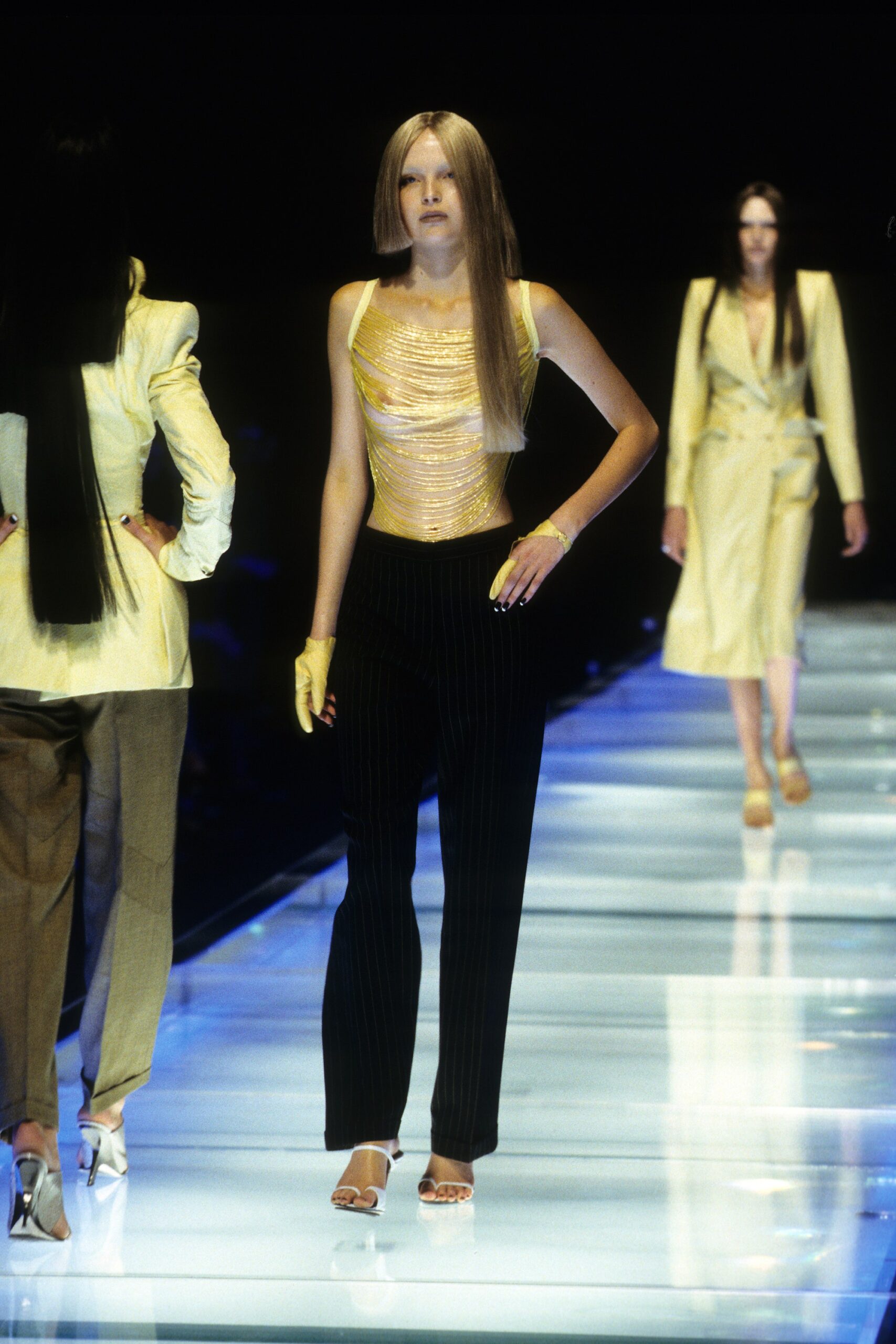 fitted gold sleeveless top and black pants