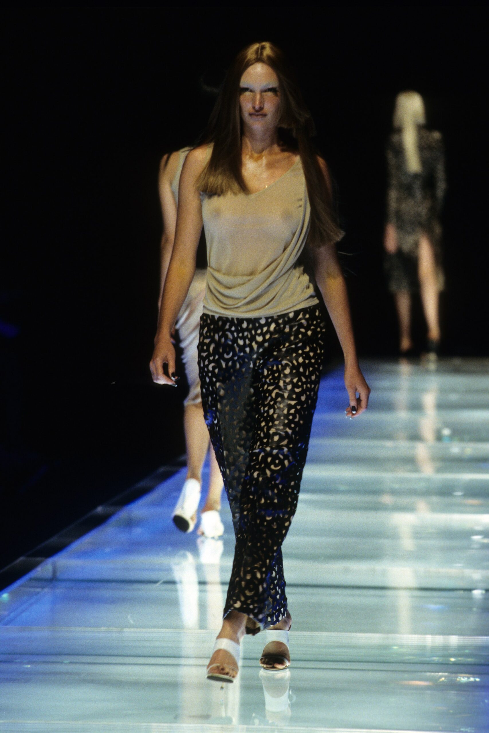 beige silk sleeveless top with black printed pants