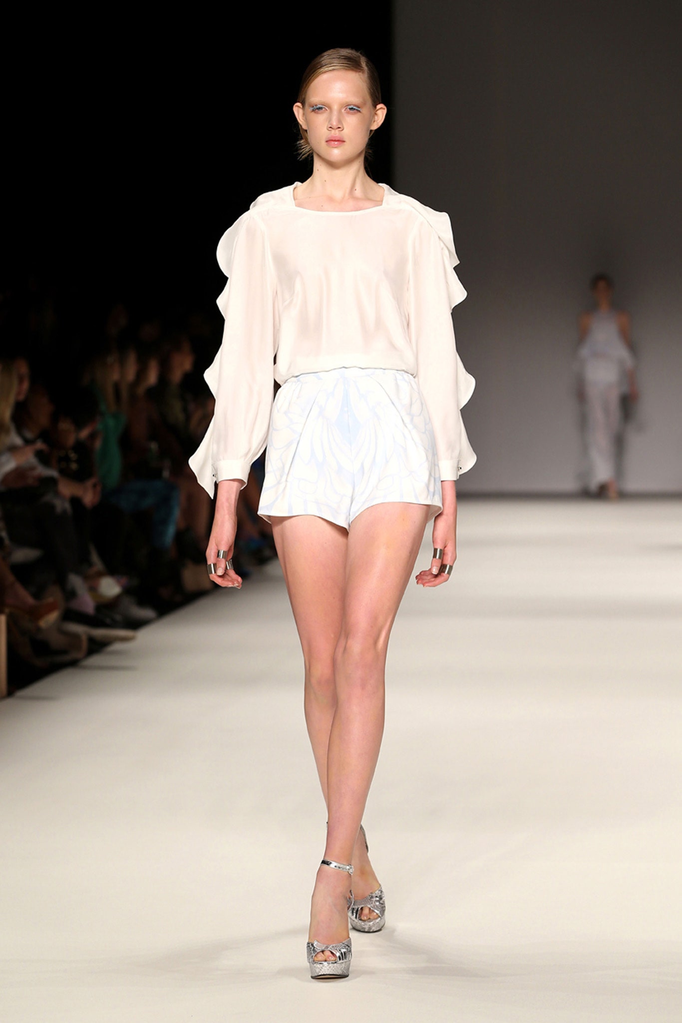 white silk blouse with pleated shorts