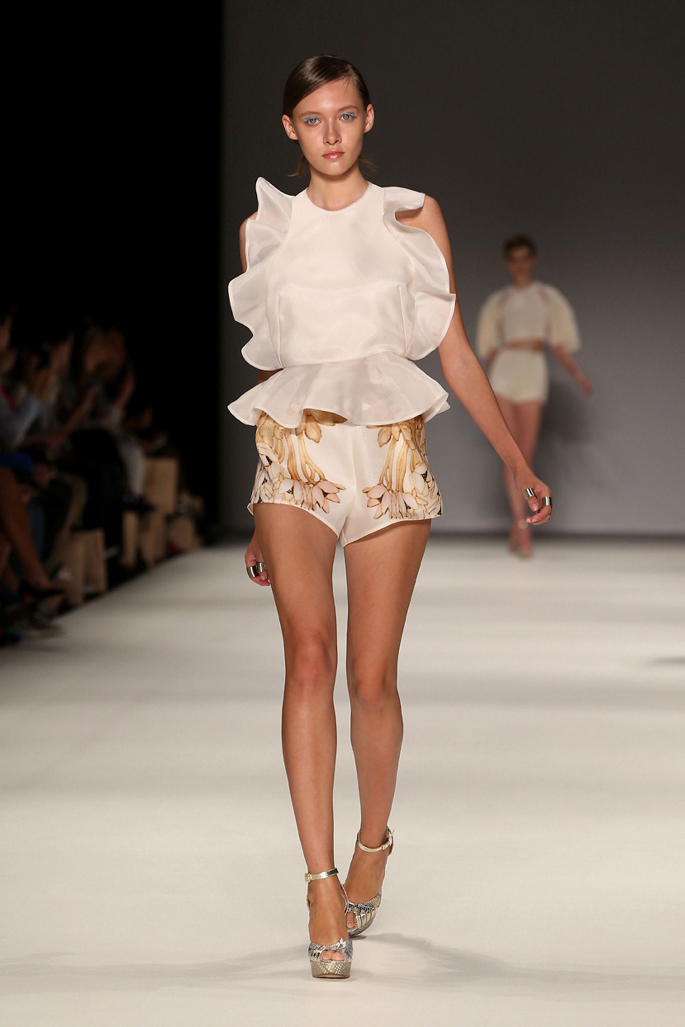 white ruffled top and beige shorts