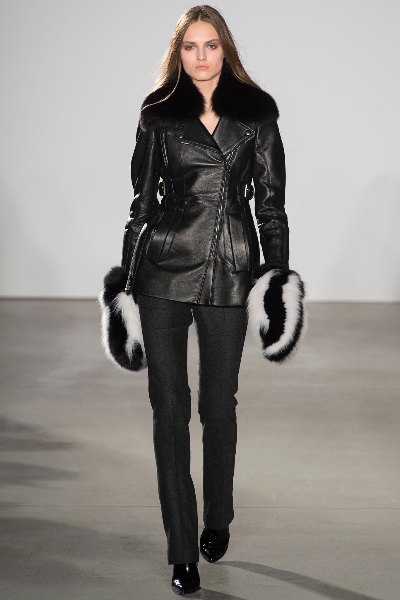 fitted black leather jacket and gray pants