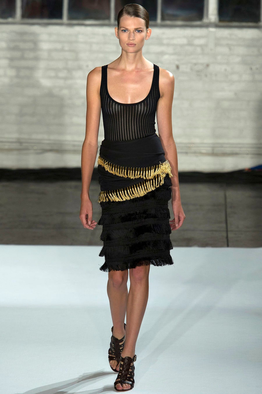 black fitted top and fringed skirt
