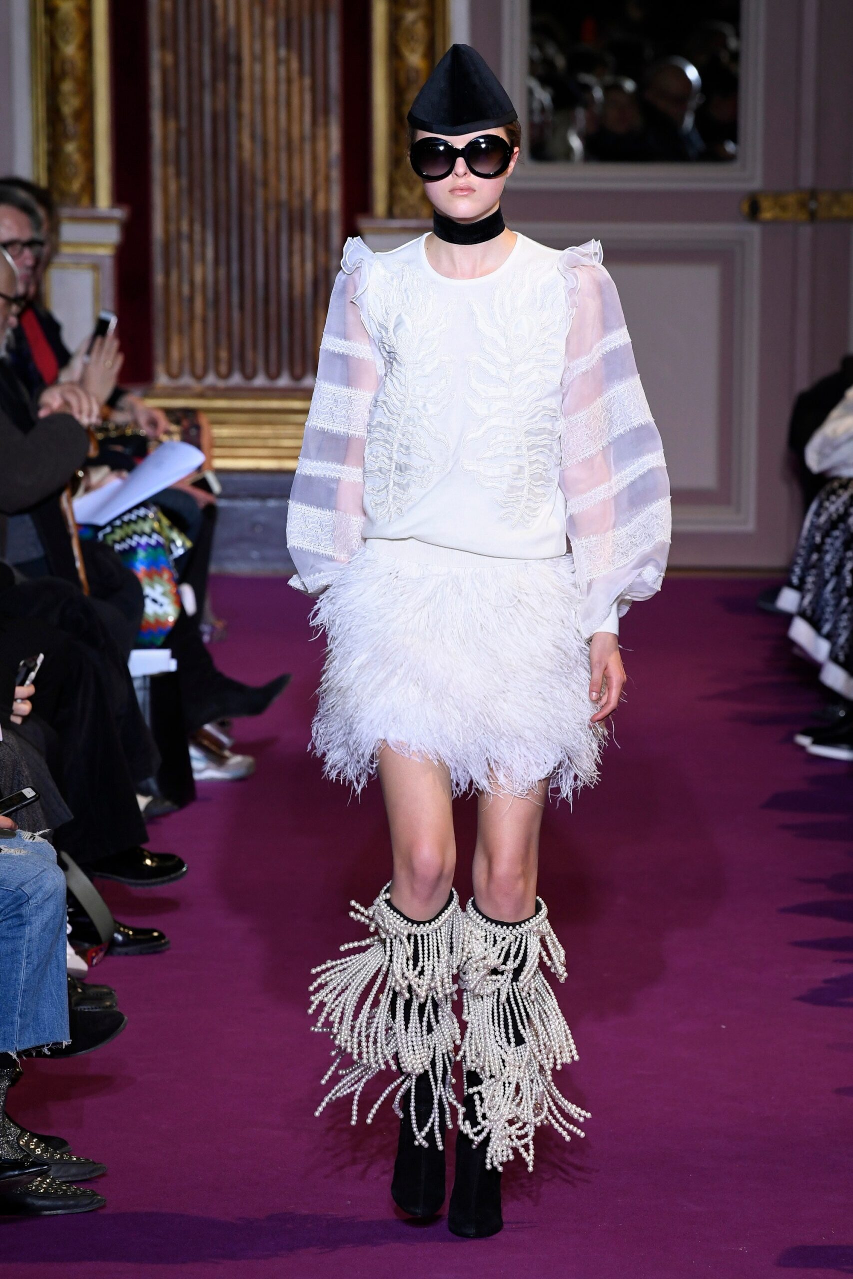 white ruffled blouse and feathered skirt