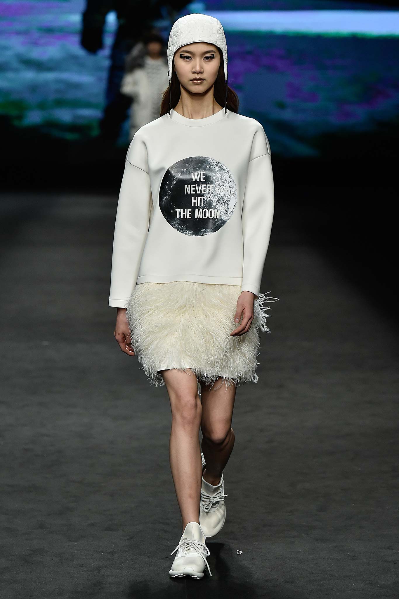 white relaxed sweater with fringed mini skirt