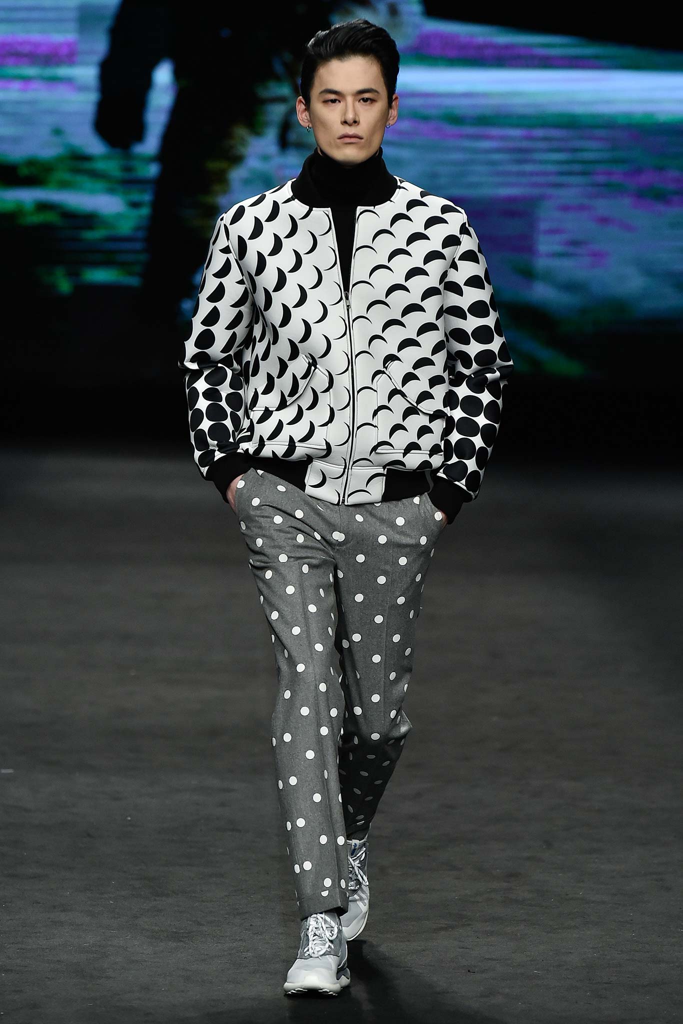 black and white printed jacket with gray pants