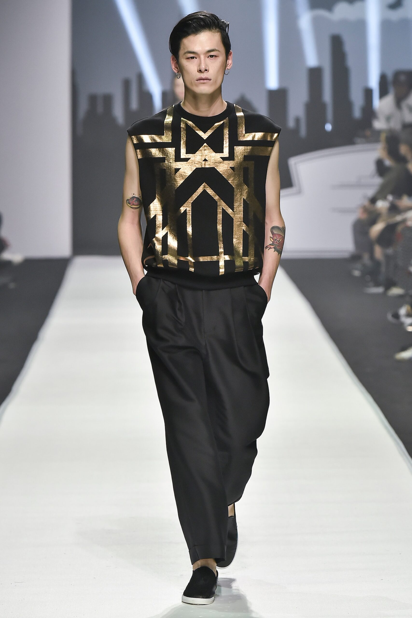 black and gold sleeveless top with relaxed pants