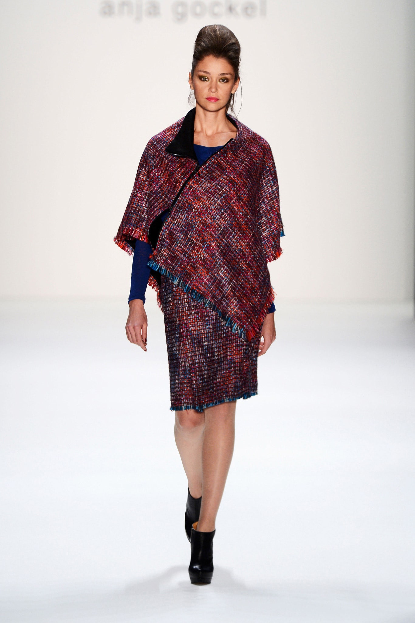 multi-colored wool poncho and blue pencil skirt