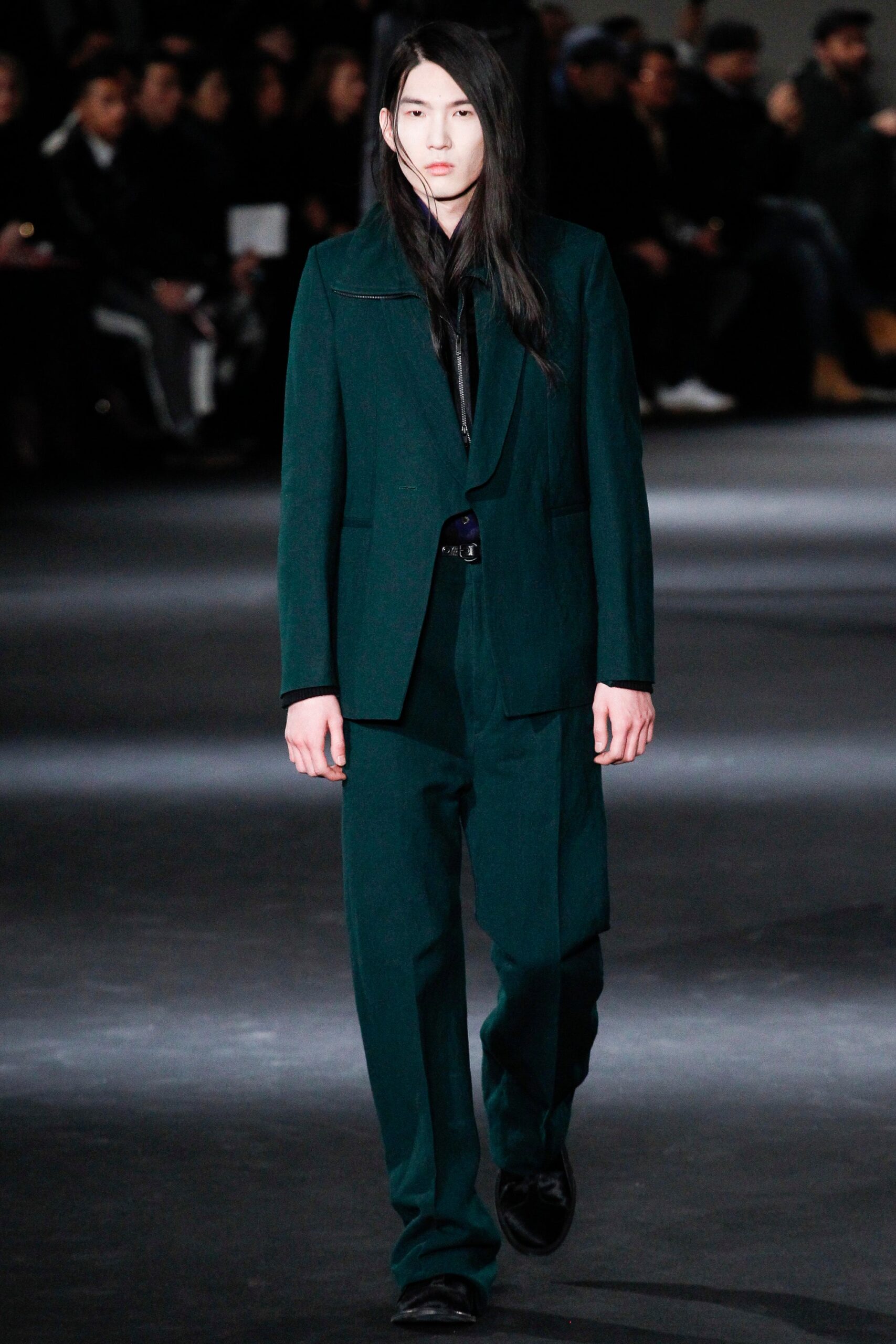 green tailored suit with black shirt