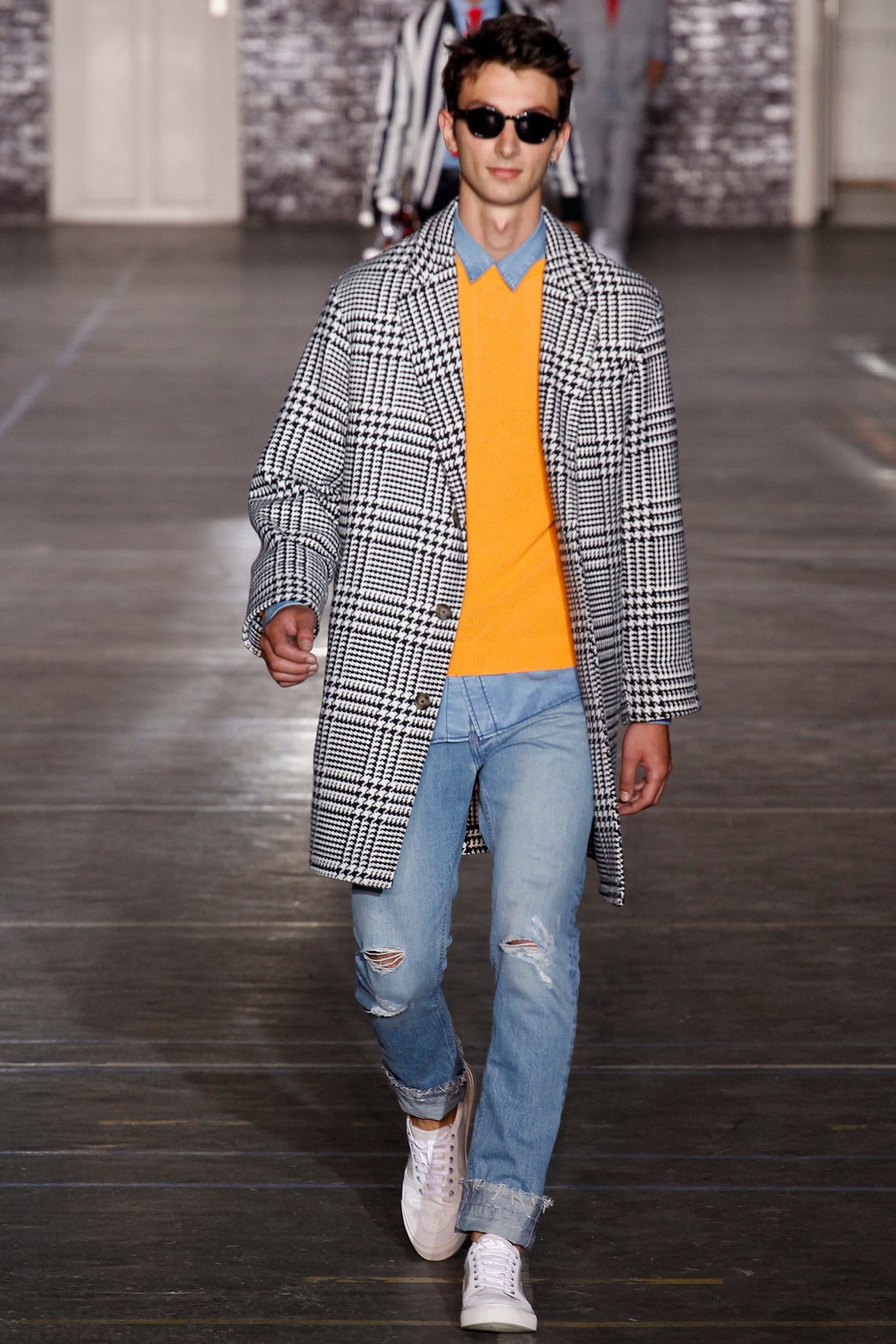 checked coat with orange sweater