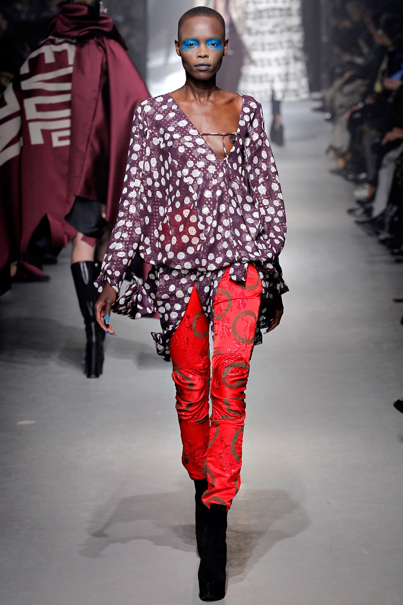 purple printed top with red pants