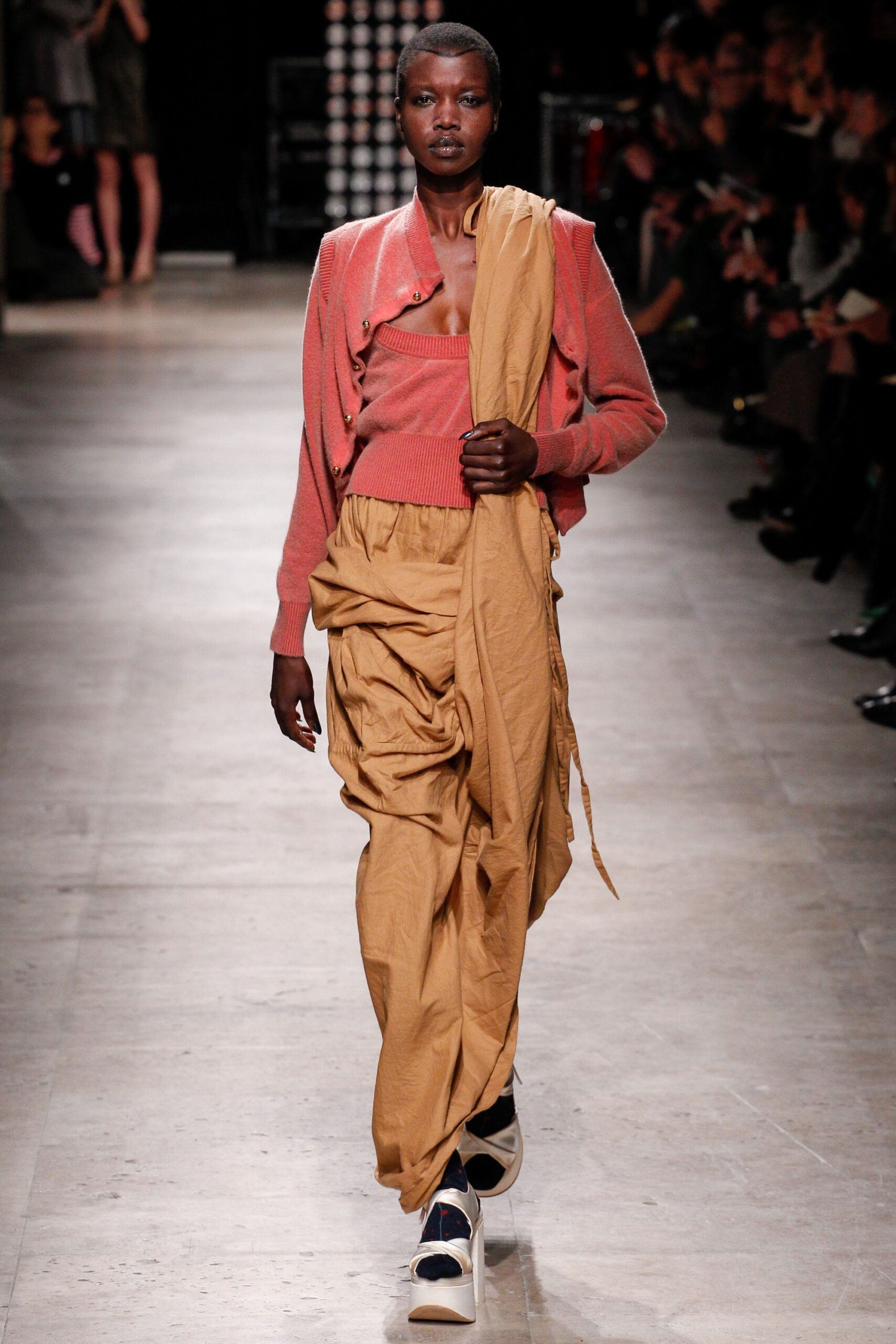 pink cardigan with beige pants