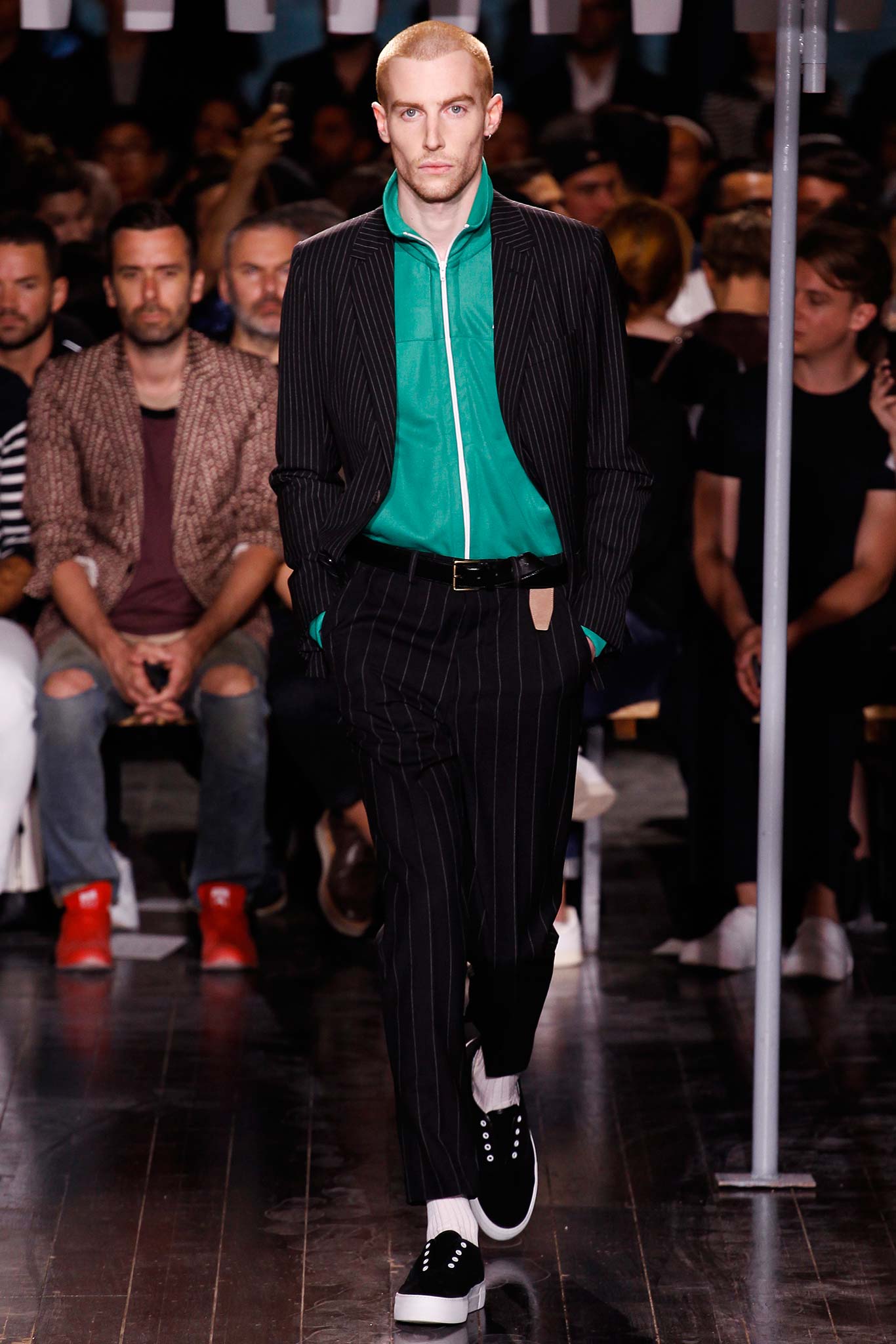 tailored black suit with green shirt