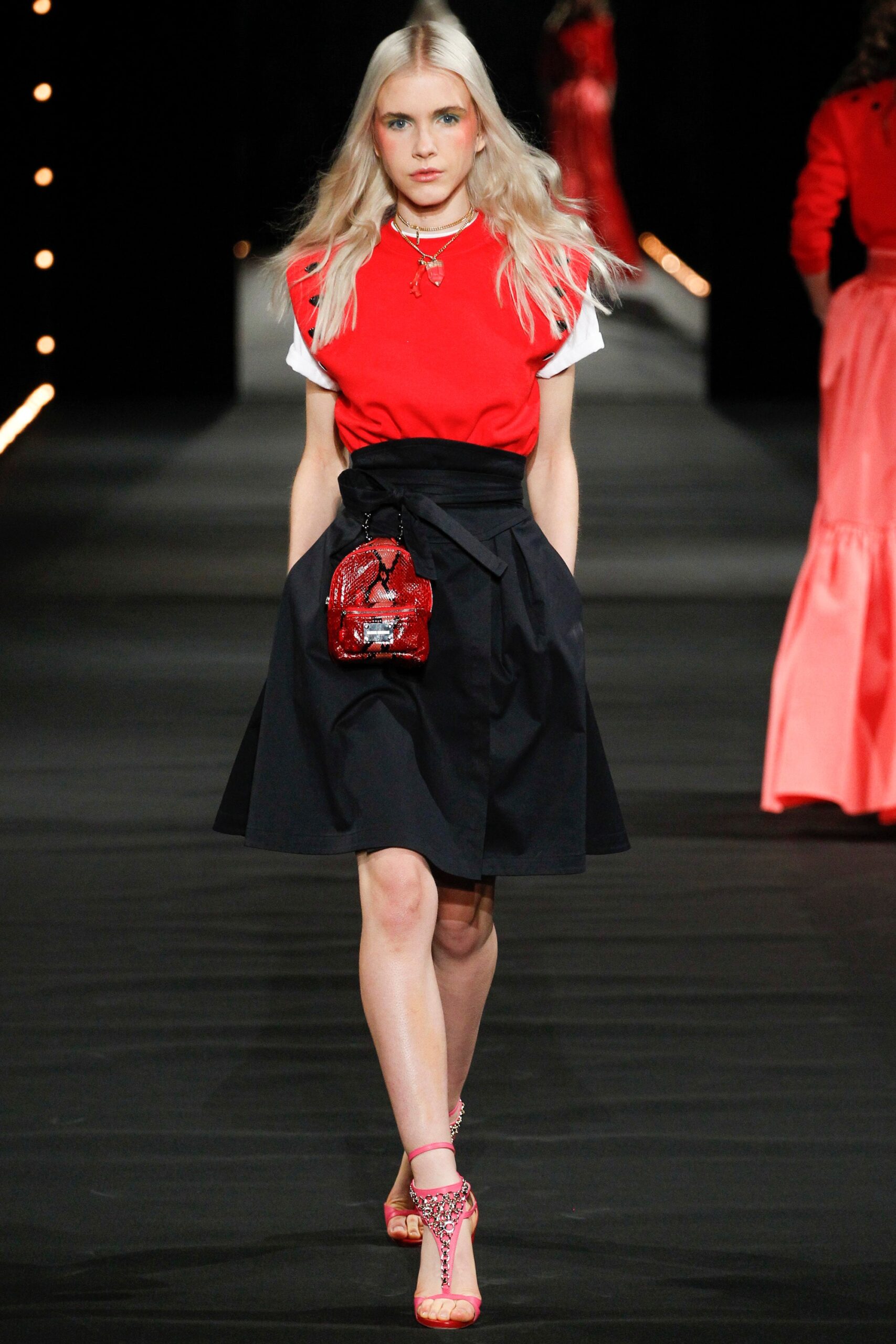 red fitted top with black skirt