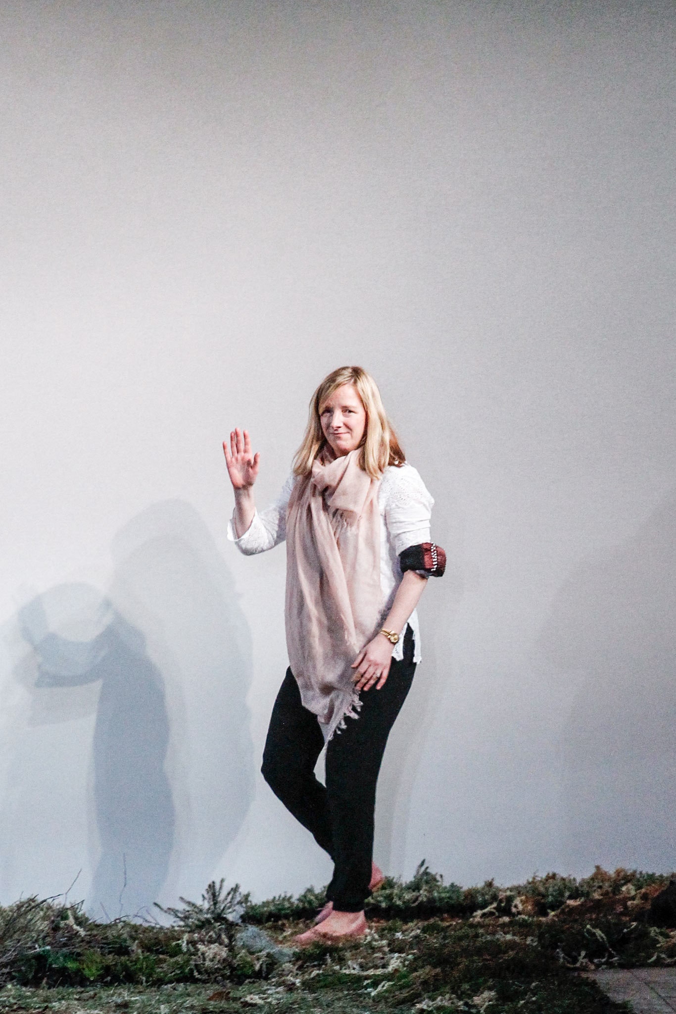 white top black pants beige scarf