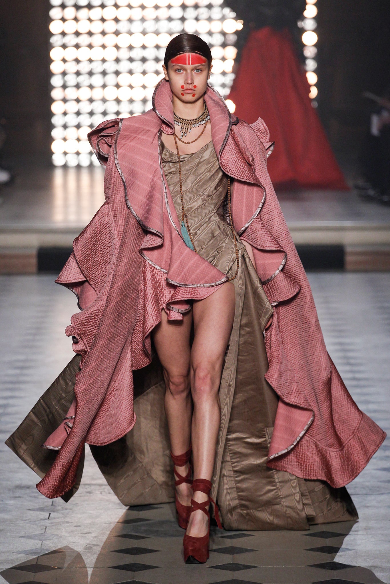 pink ruffled dress with oversized cape