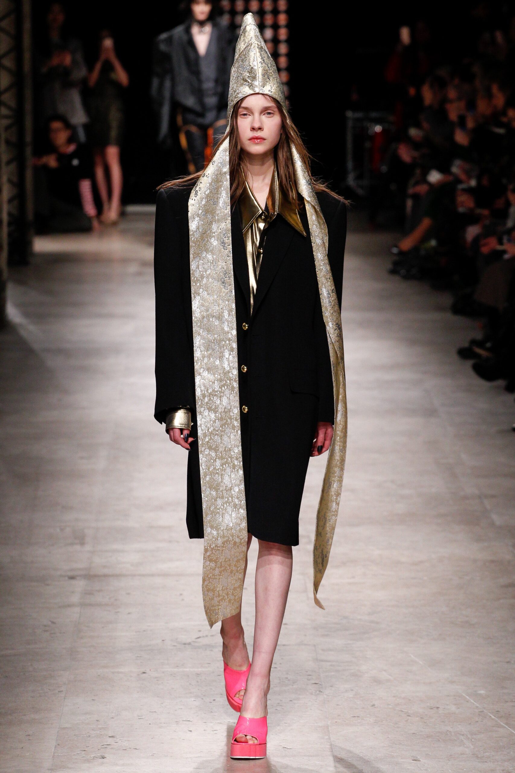 black blazer with gold hat