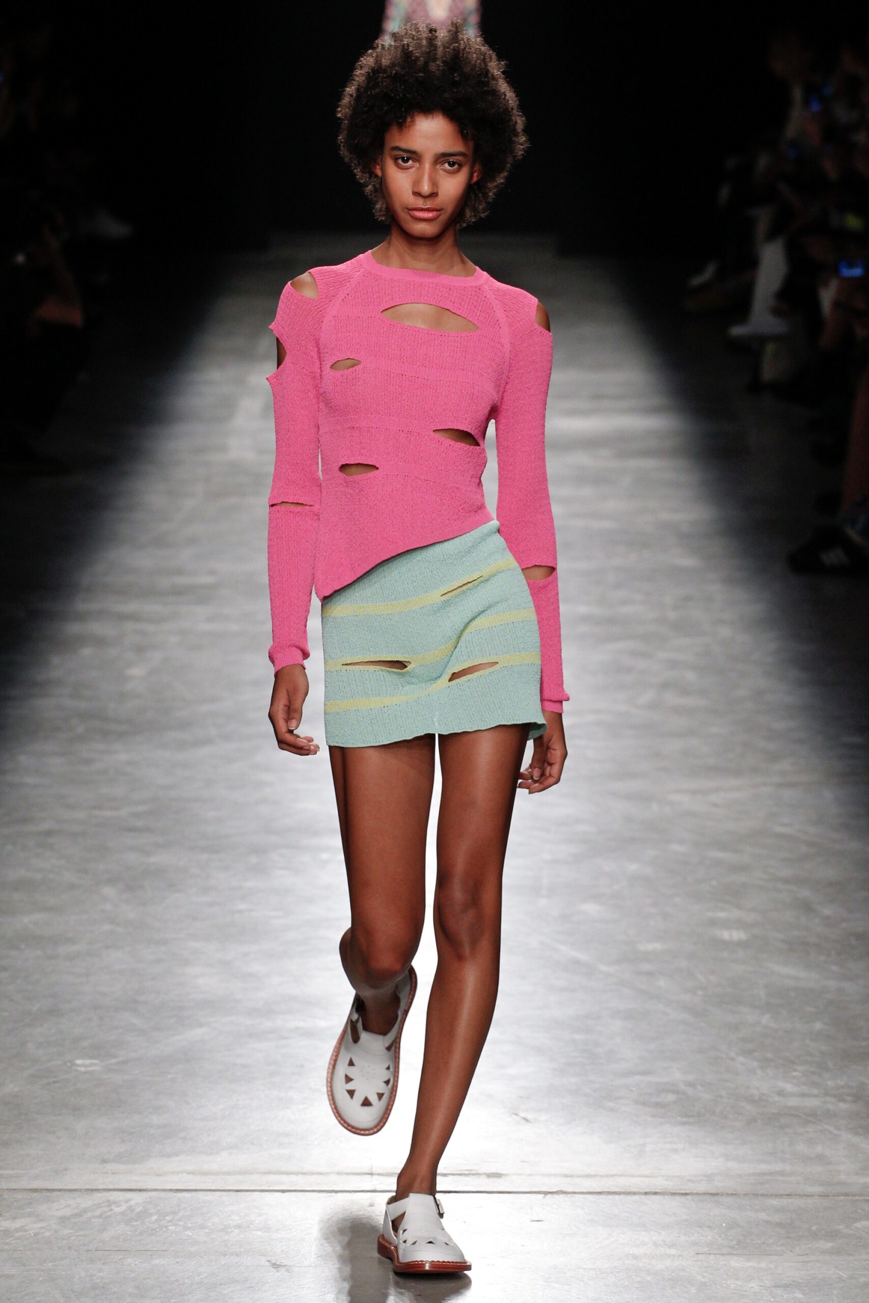 pink cutout long-sleeve top and blue mini skirt