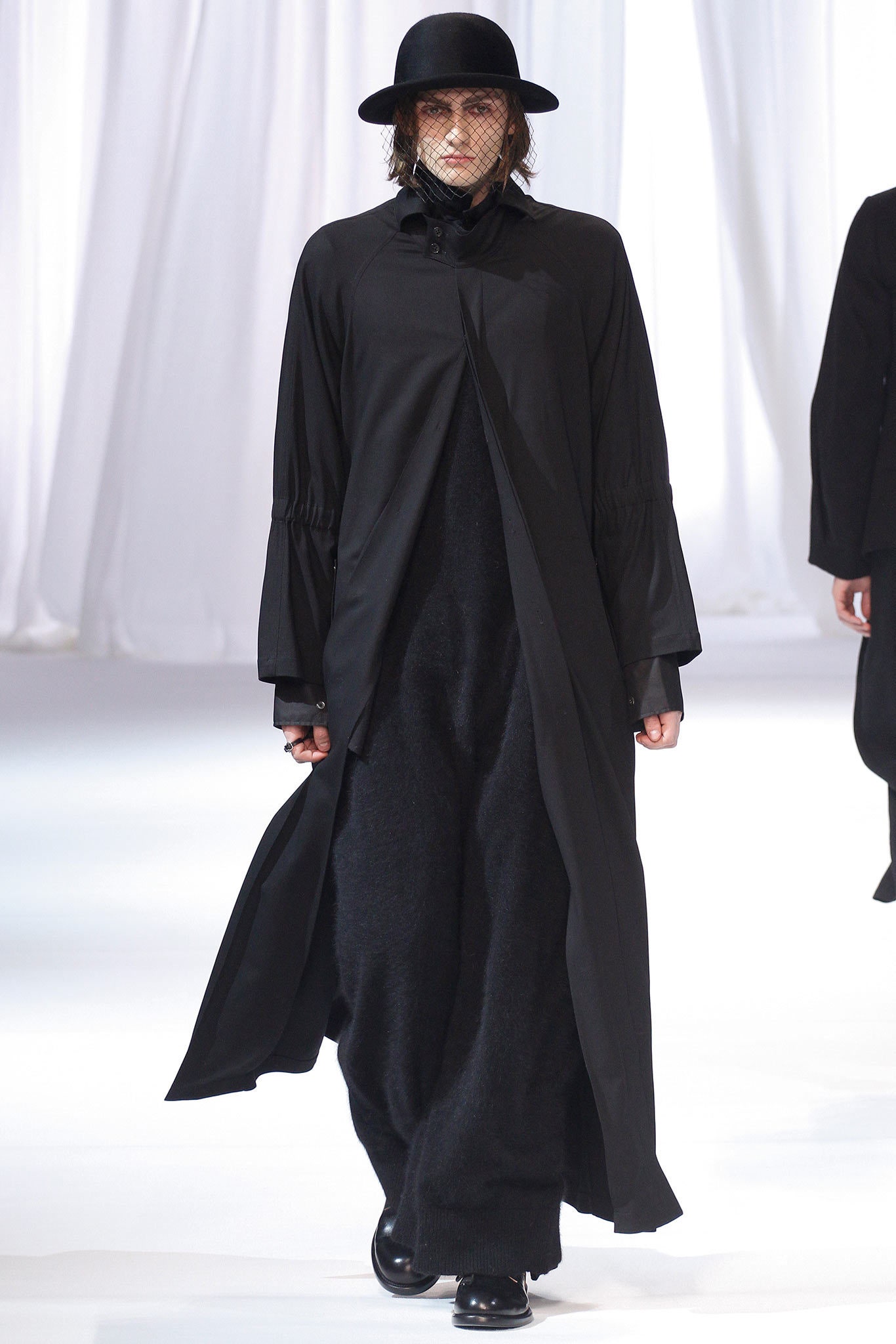 black relaxed coat and fitted dress