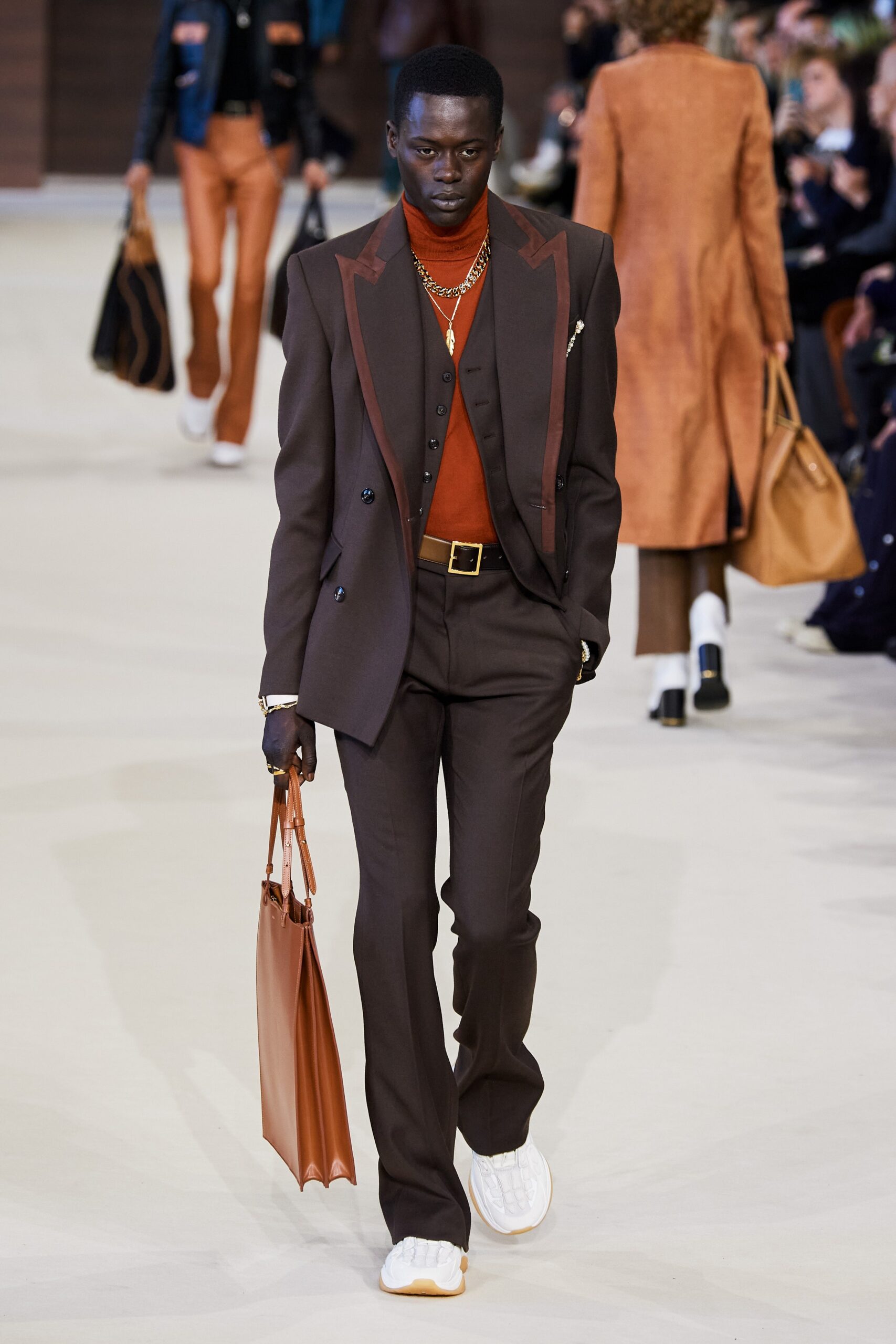 brown tailored suit with orange shirt