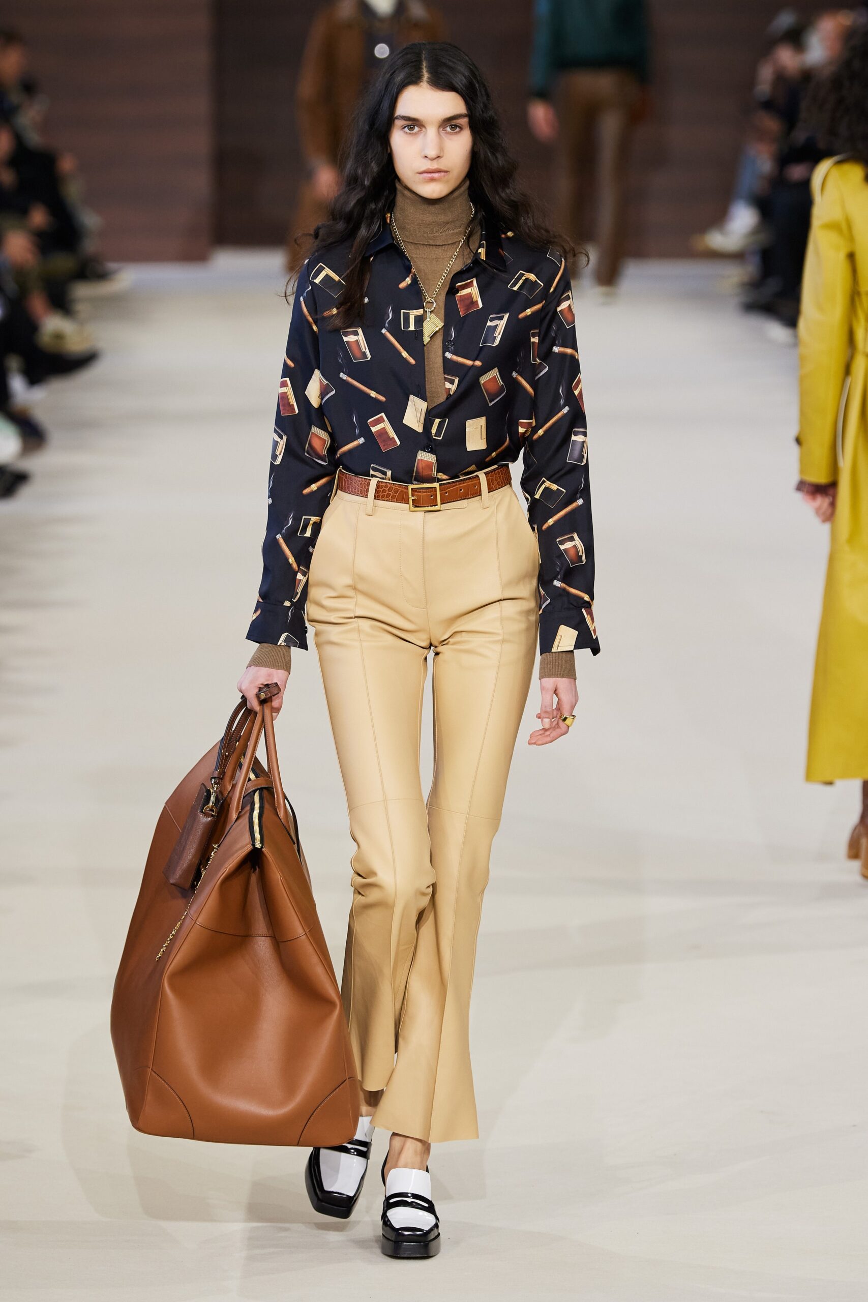 fitted black printed shirt with beige flared pants