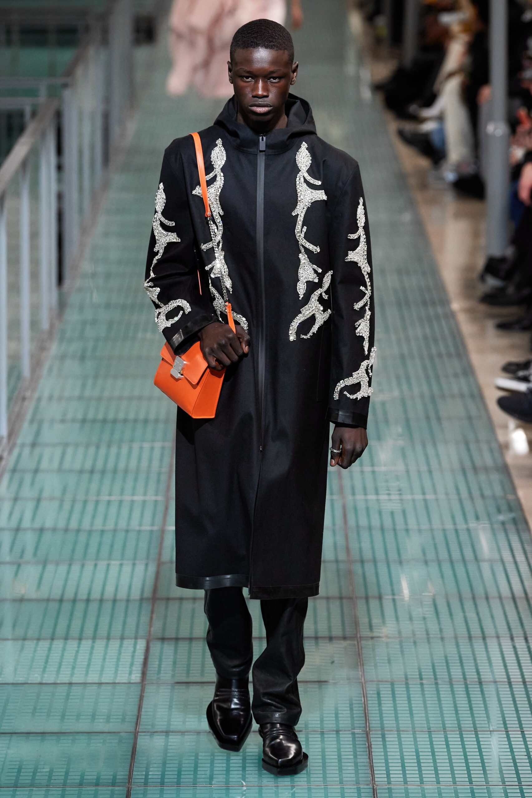 black embroidered coat with orange bag