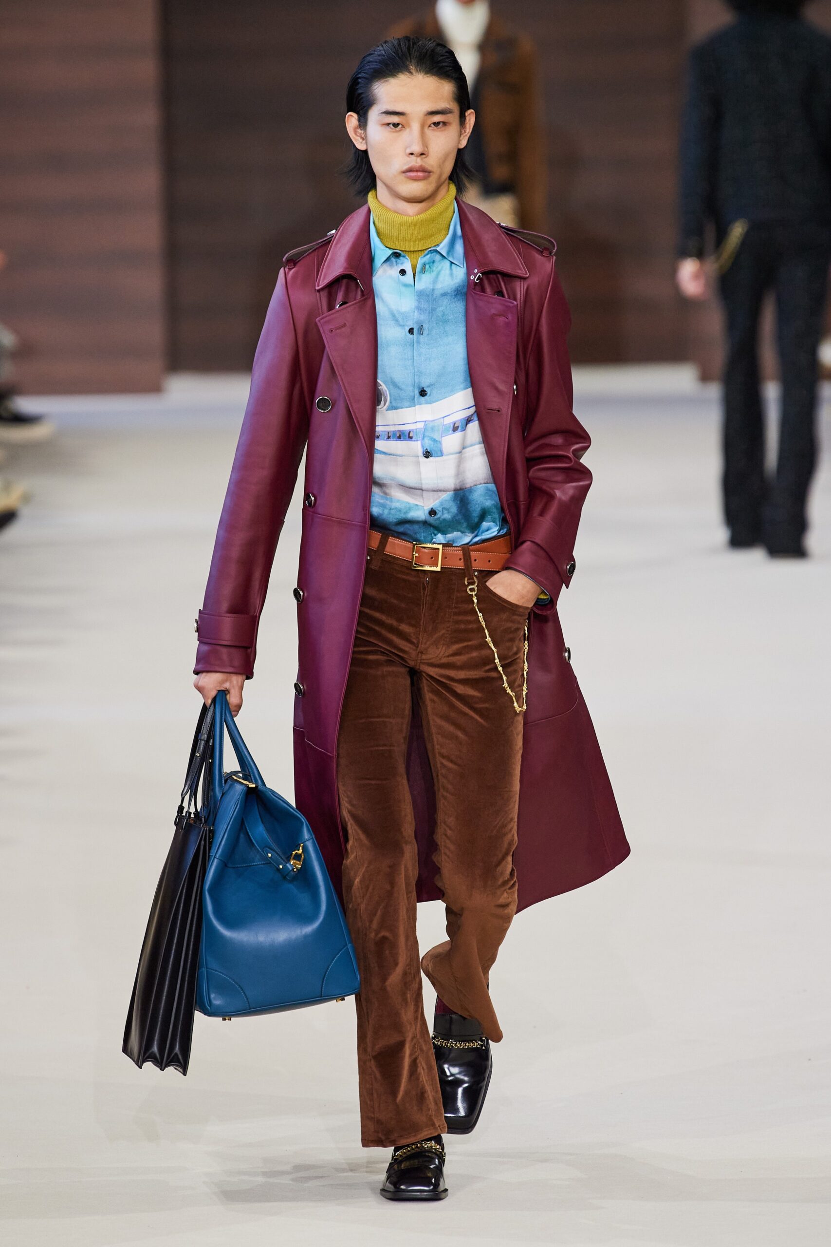 red leather long-sleeve collared fitted buttoned trench