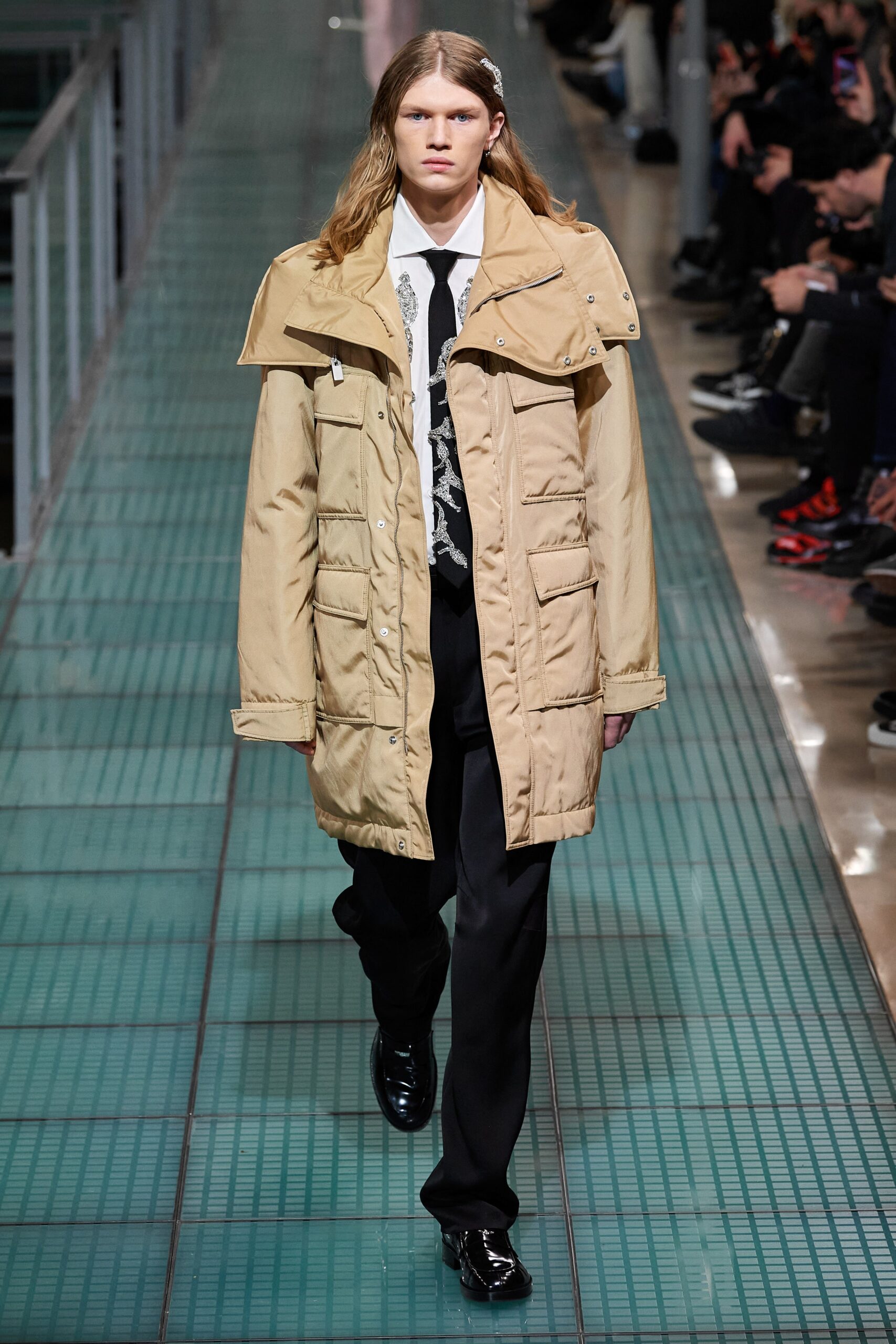 beige relaxed coat and black tailored pants