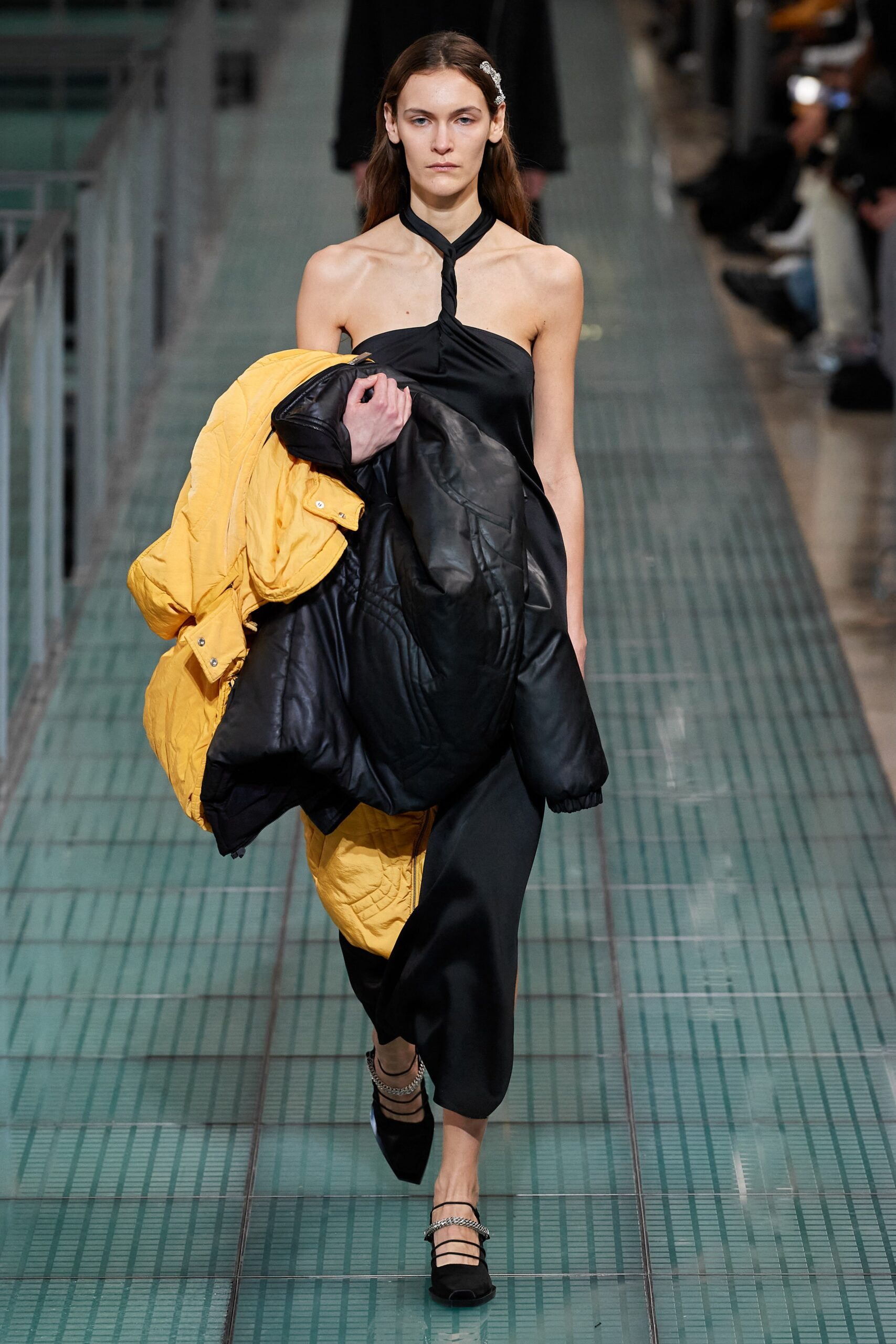black silk sleeveless dress and yellow oversized coat