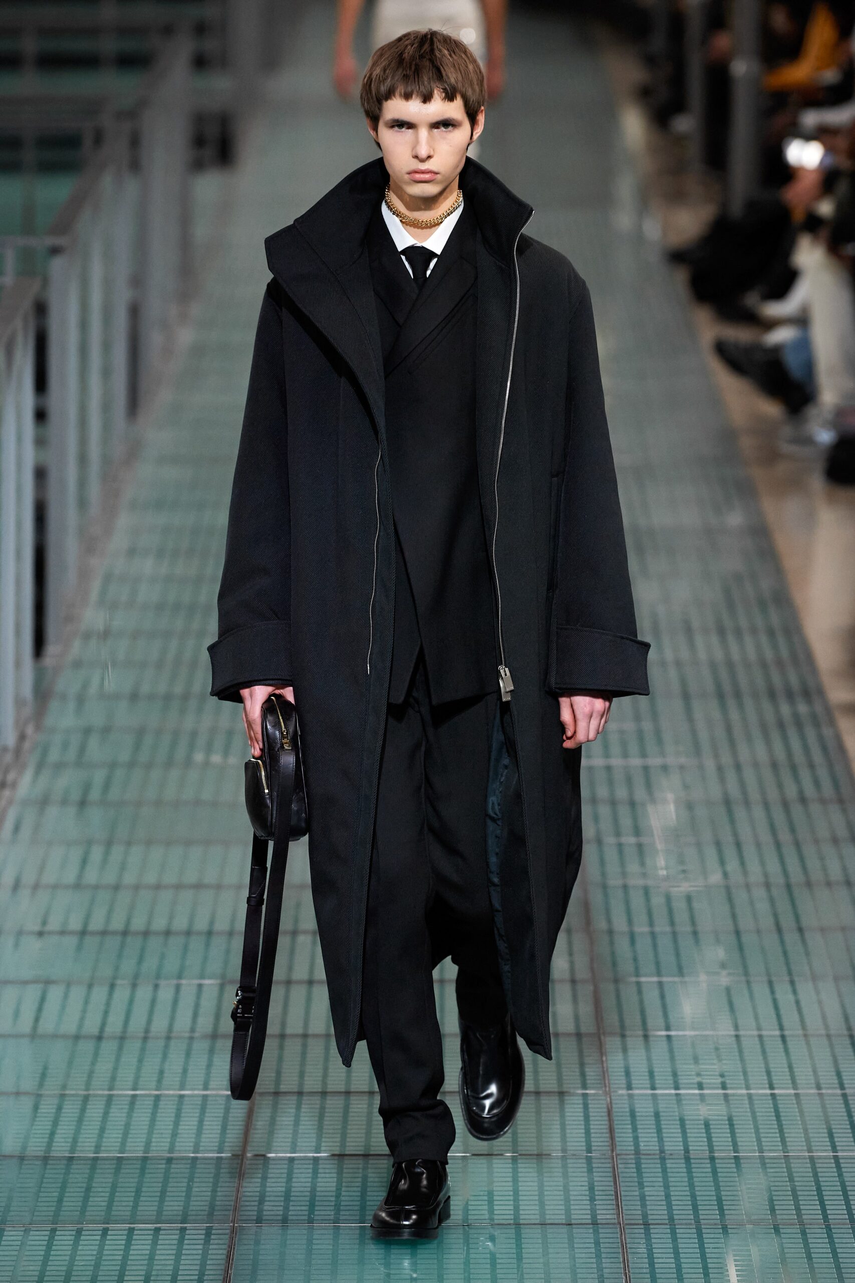 black oversized coat and tailored suit