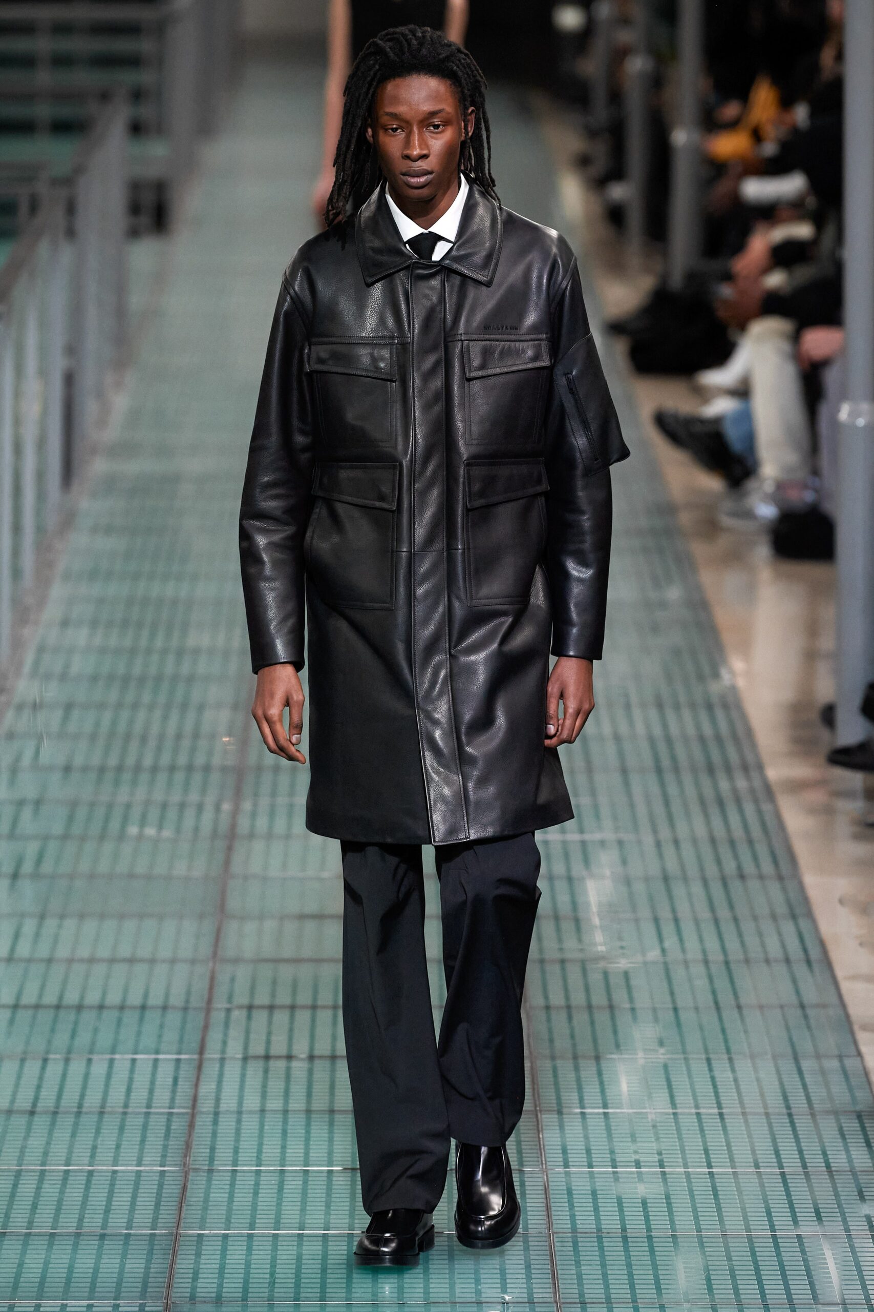 black leather coat and tailored pants