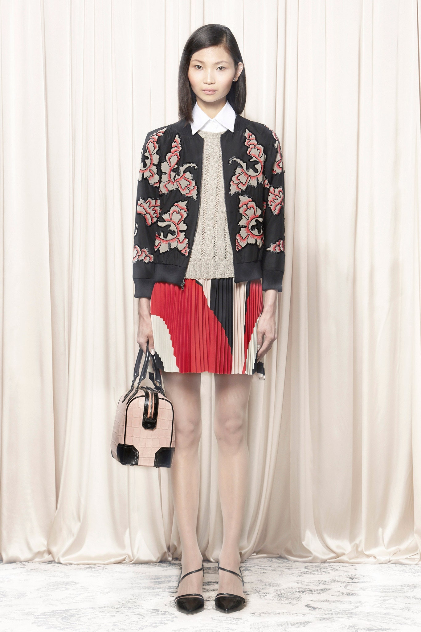 embroidered black jacket with pleated skirt