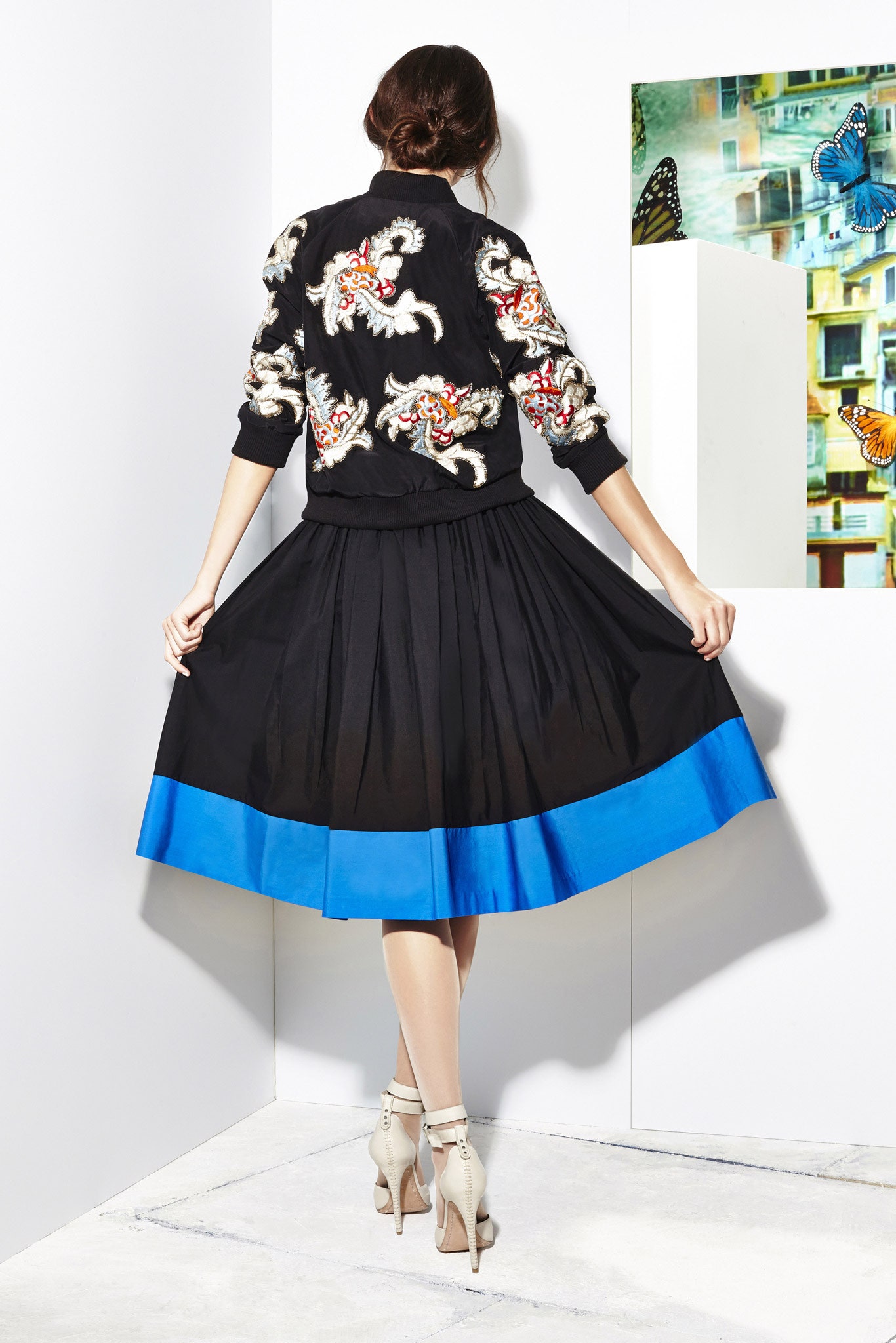 black embroidered jacket with pleated skirt