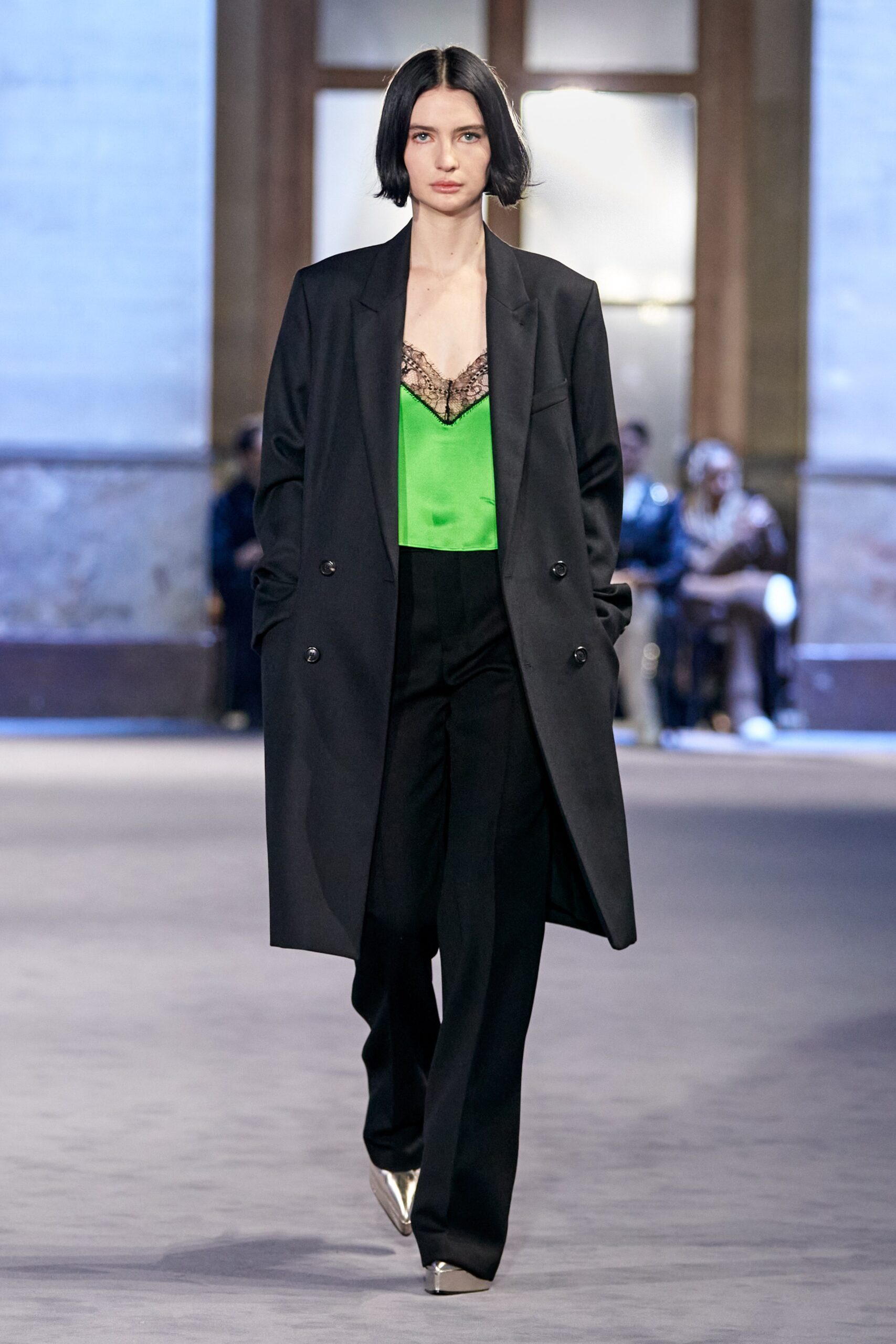 black coat green silk top black tailored pants