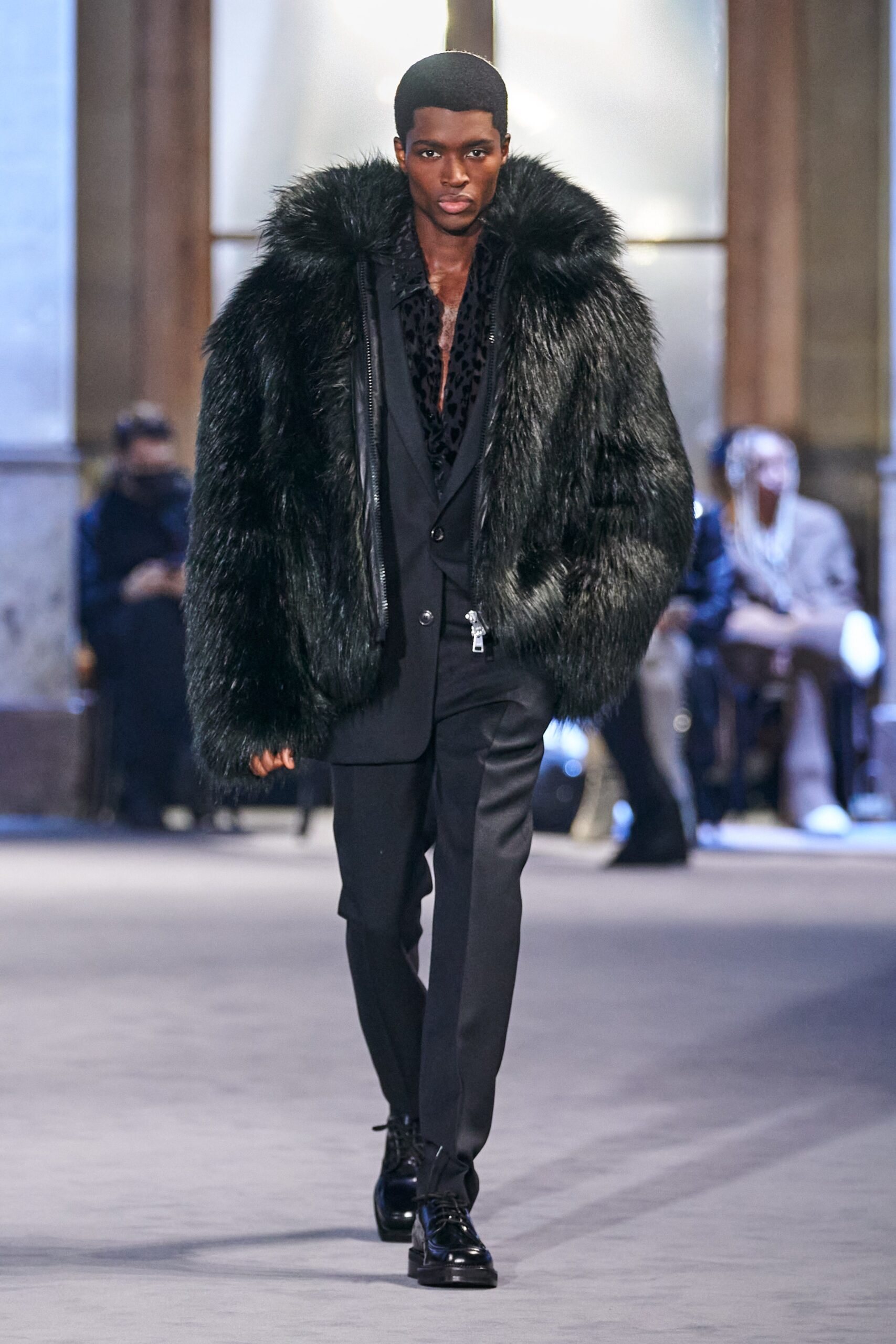 black faux-fur coat with tailored suit