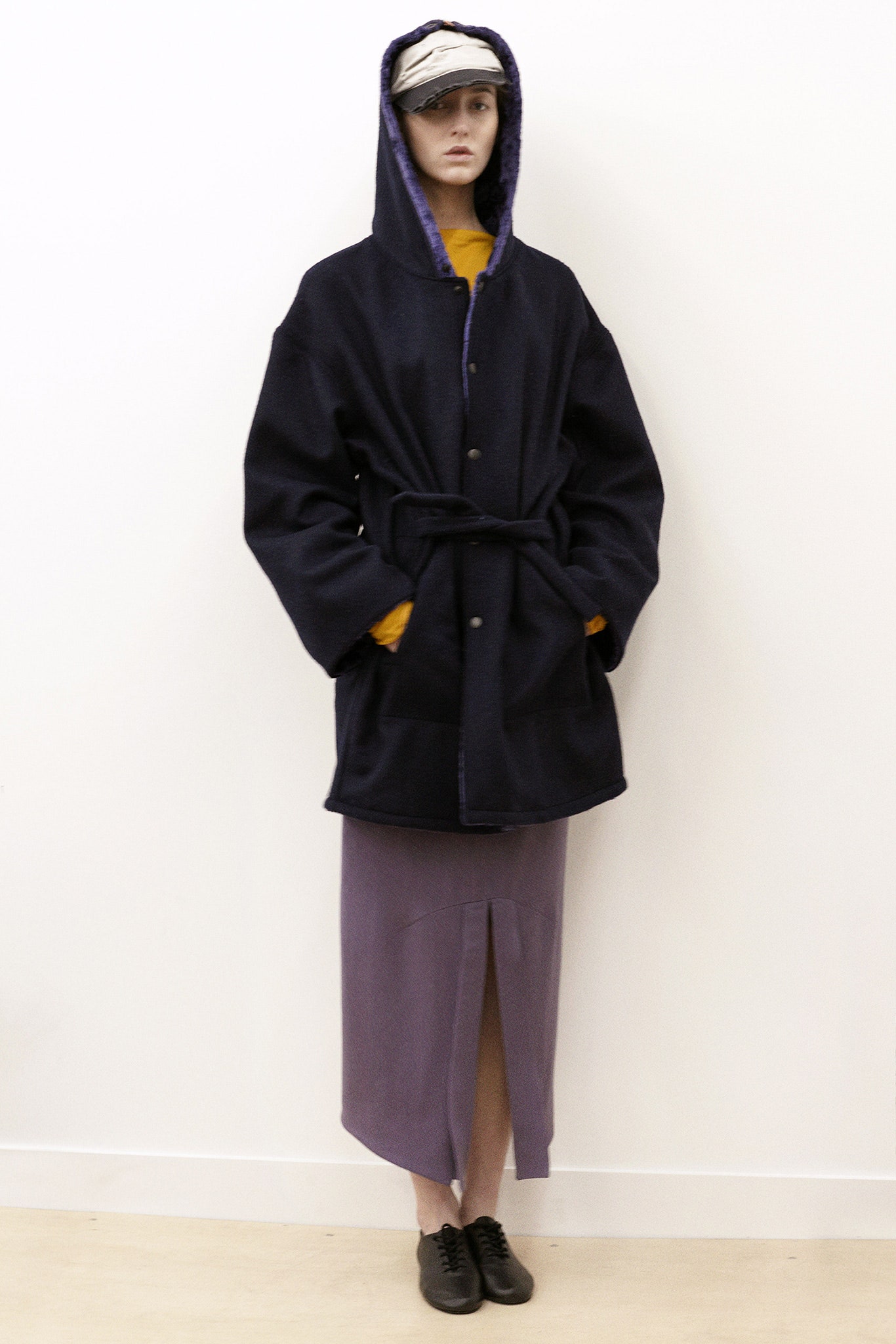 black wool relaxed coat and purple midi skirt