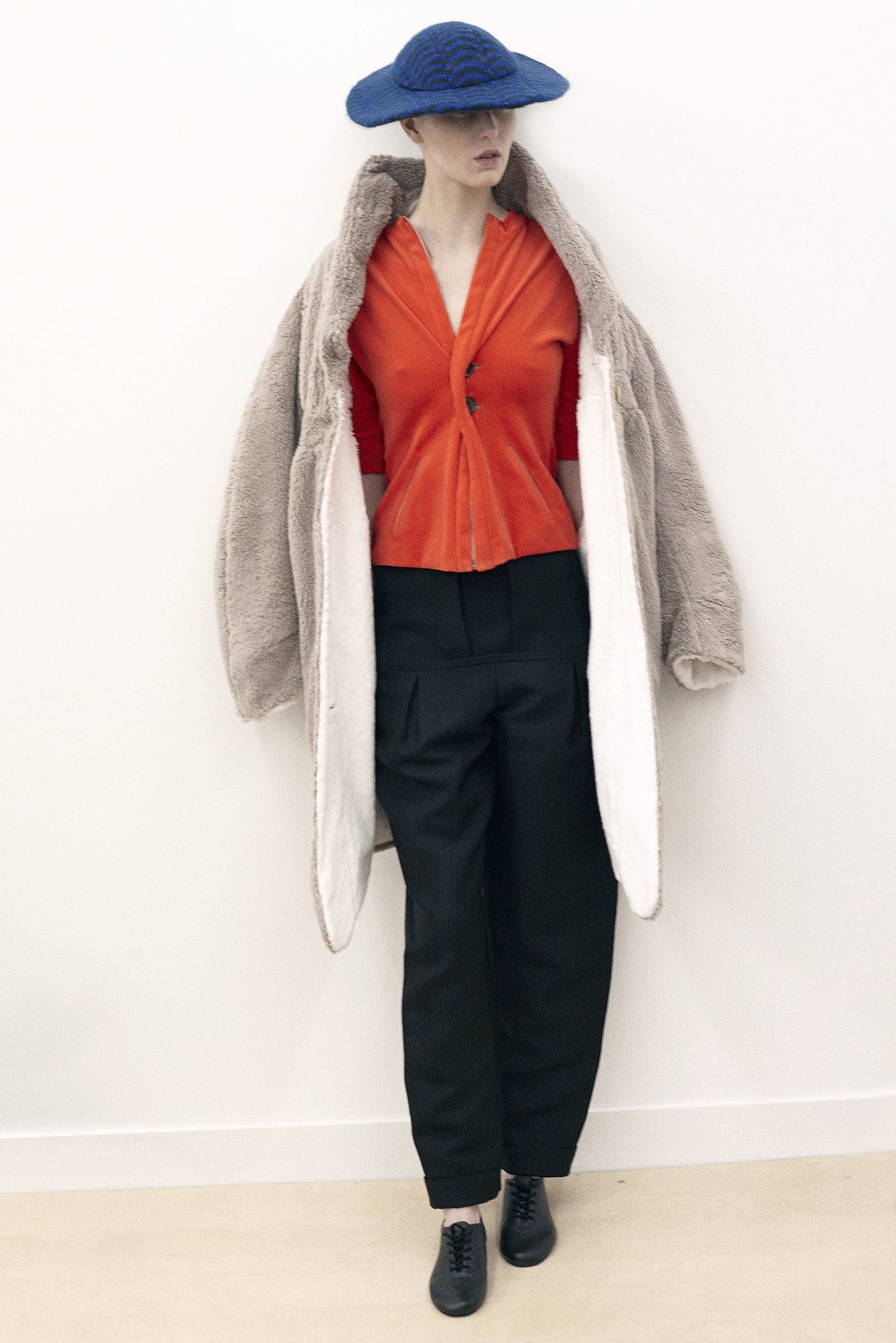 oversized faux-fur coat with red blouse