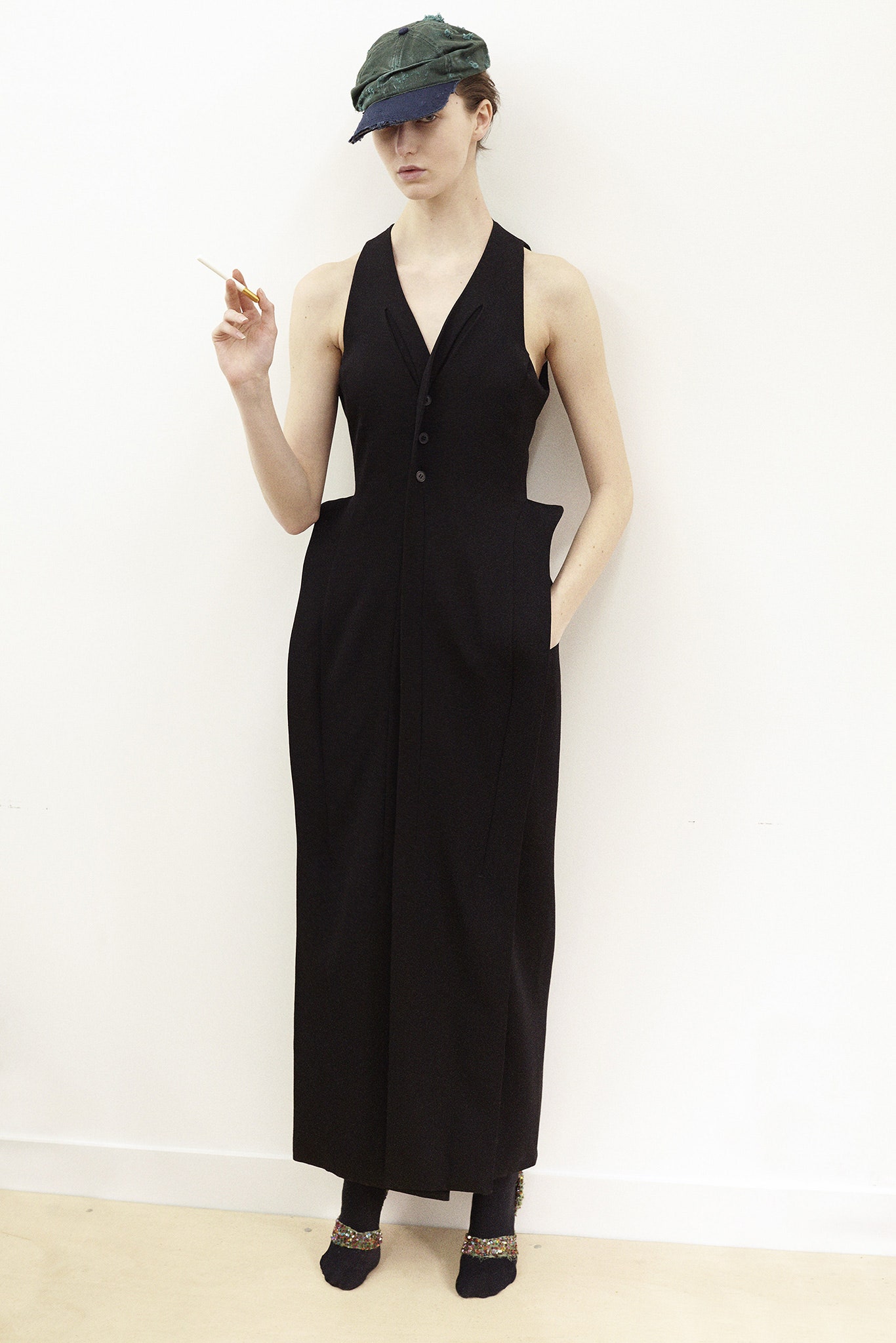 black fitted maxi dress and green hat