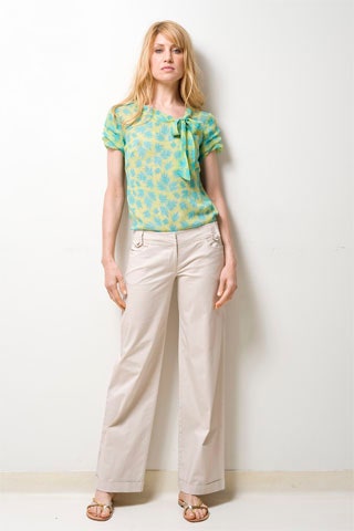 green printed top with beige pants