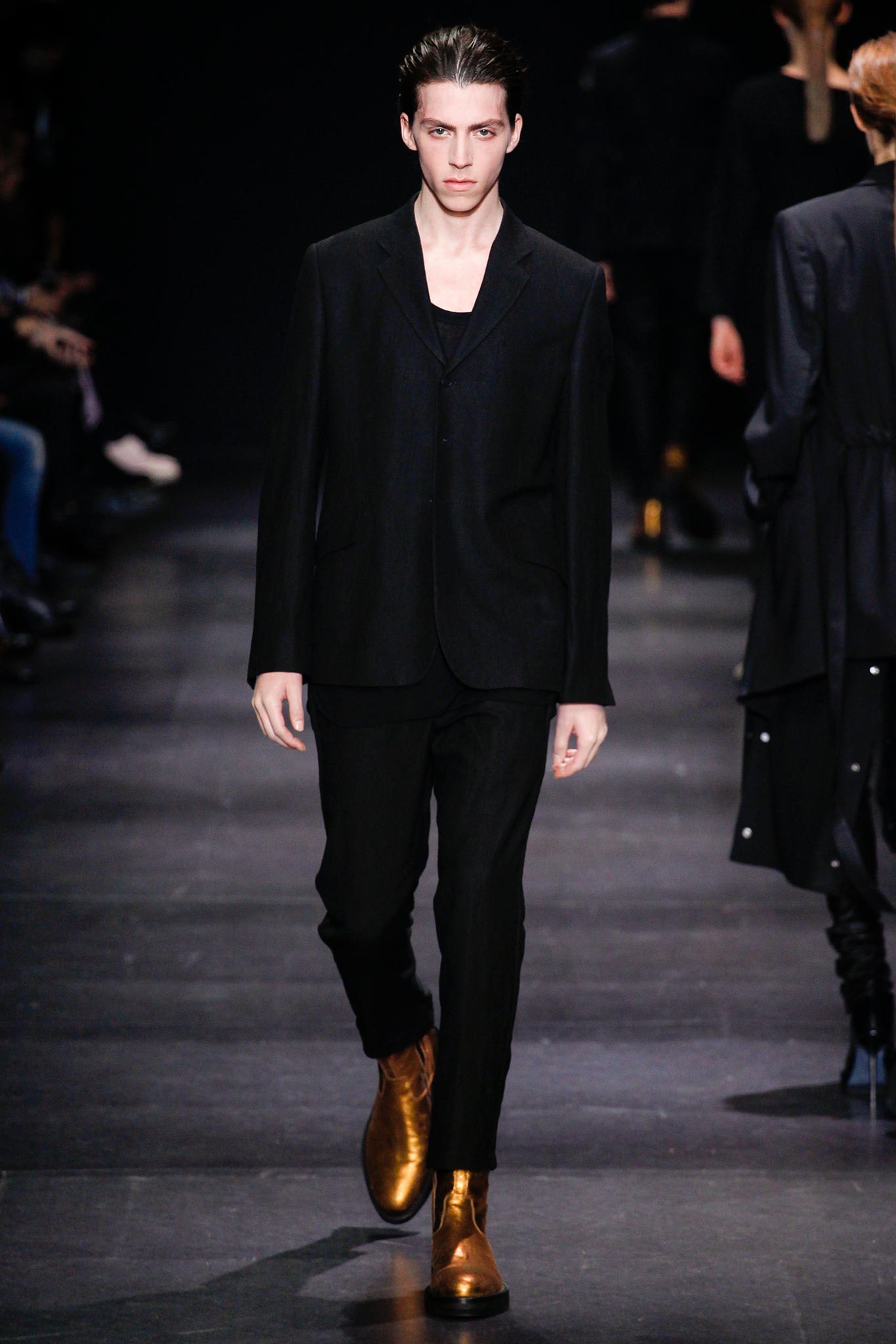 black tailored suit with gold shoes