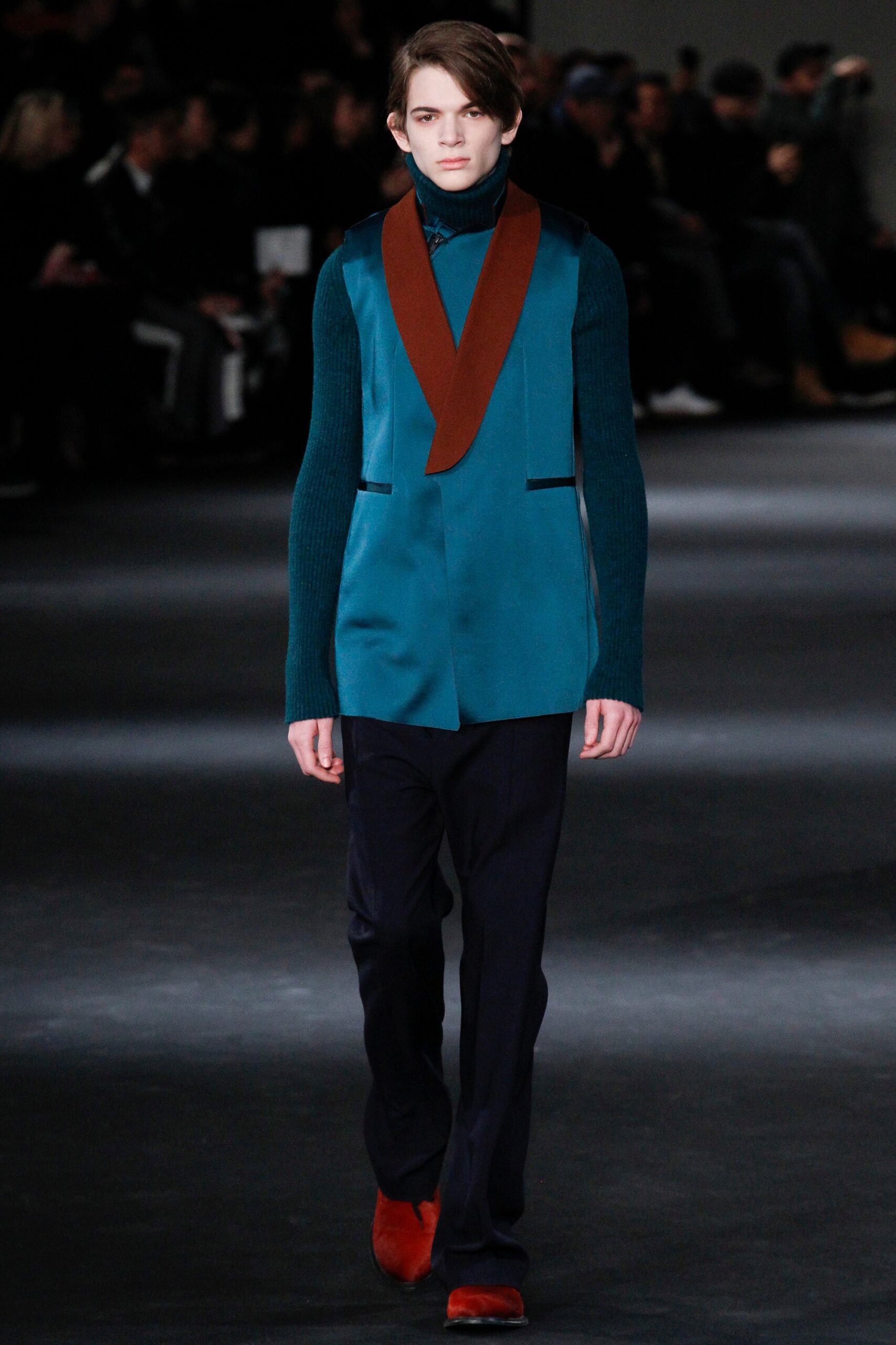 teal fitted vest with navy pants