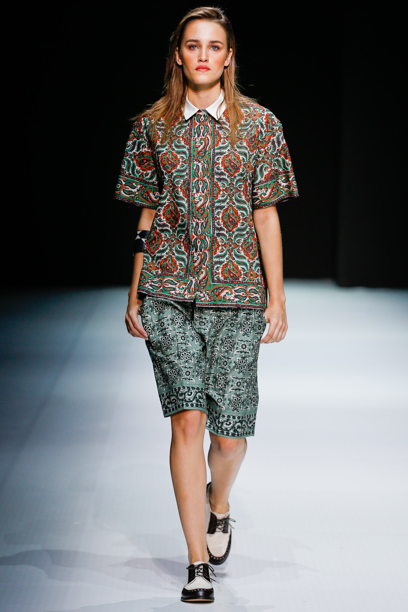 multi-colored printed shirt and green shorts