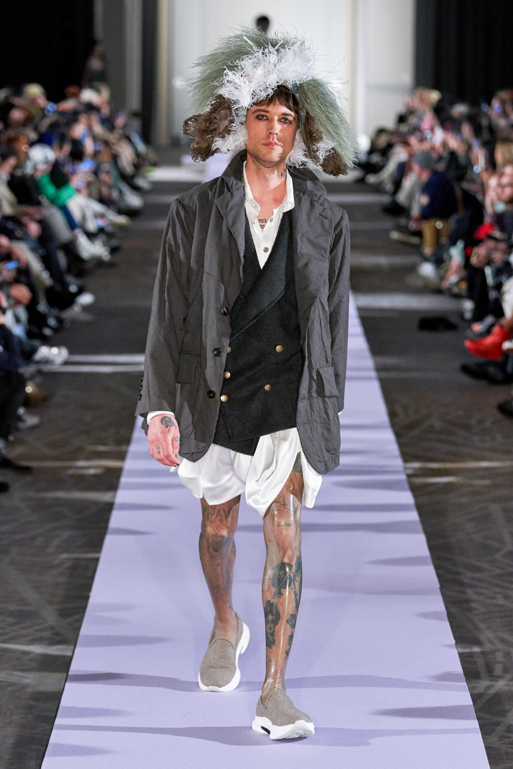 gray jacket black vest white shirt white shorts