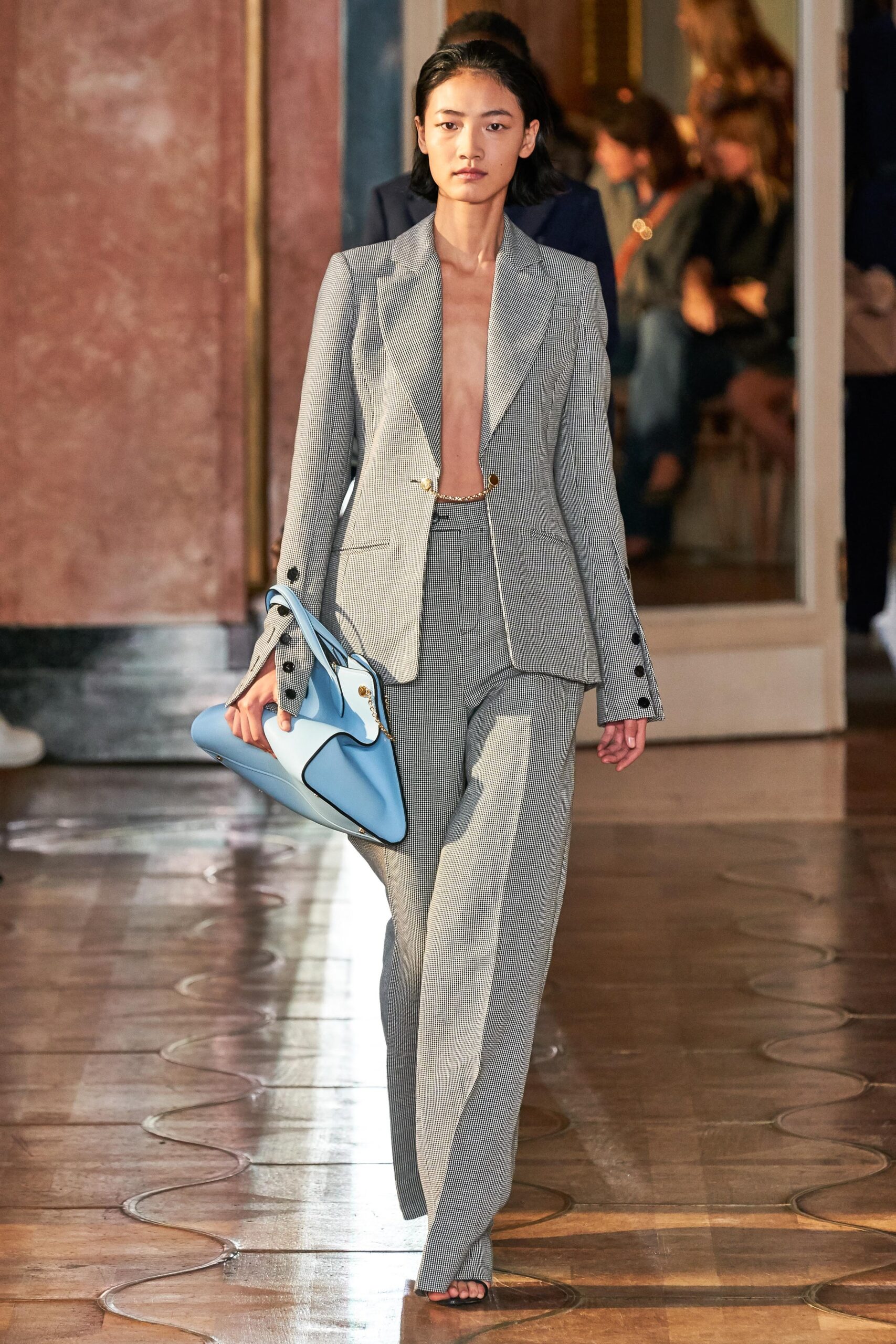 gray tailored suit with blue bag