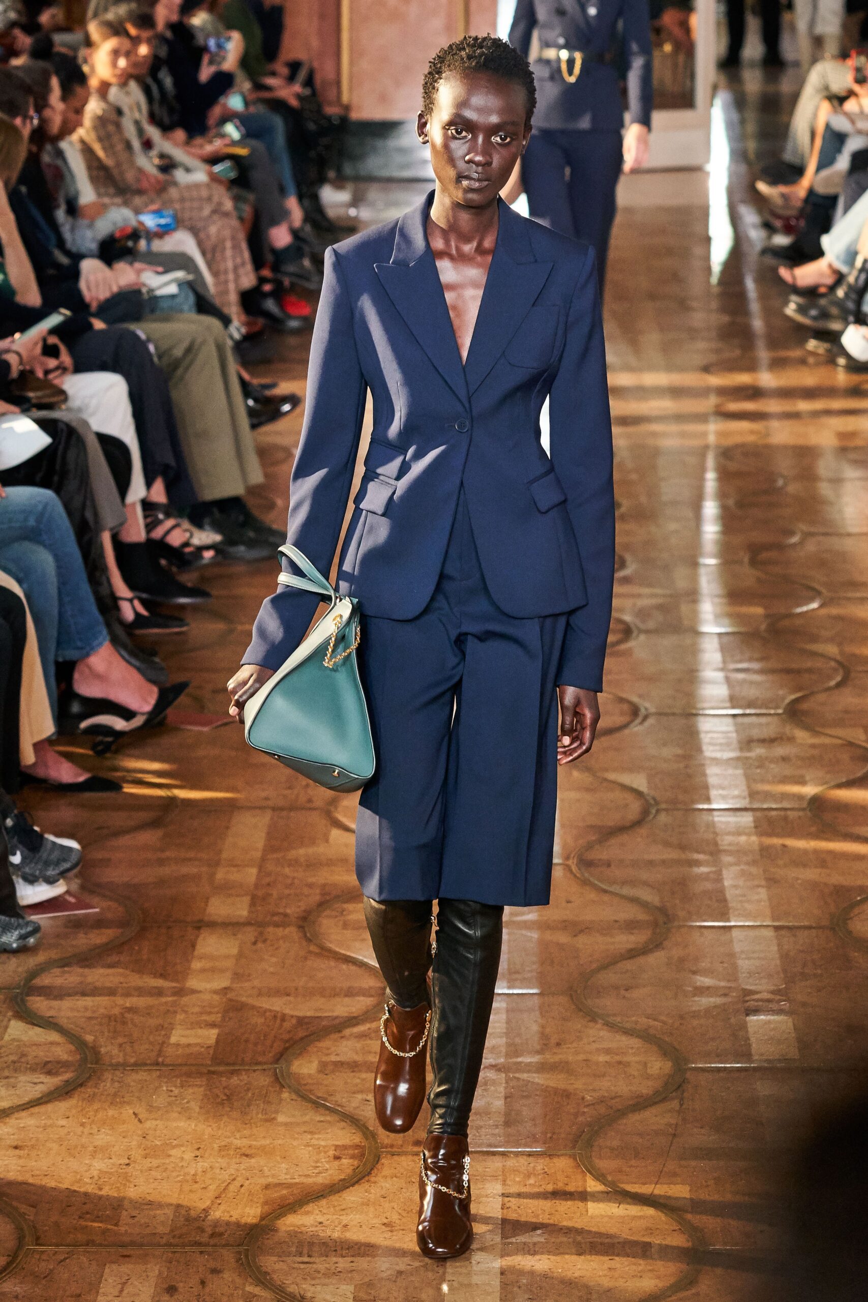 blue tailored suit with bag