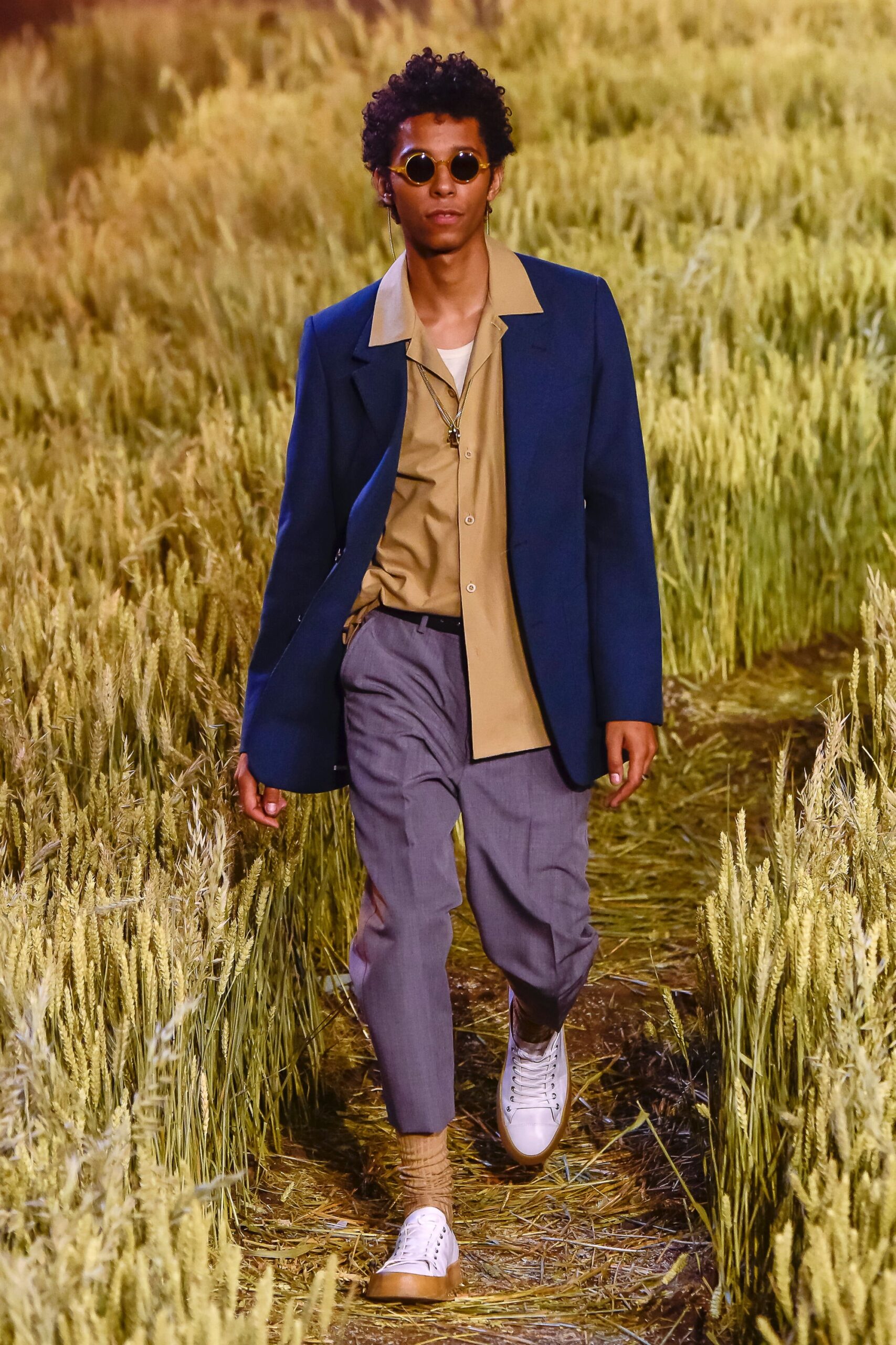 blue jacket beige shirt gray pants